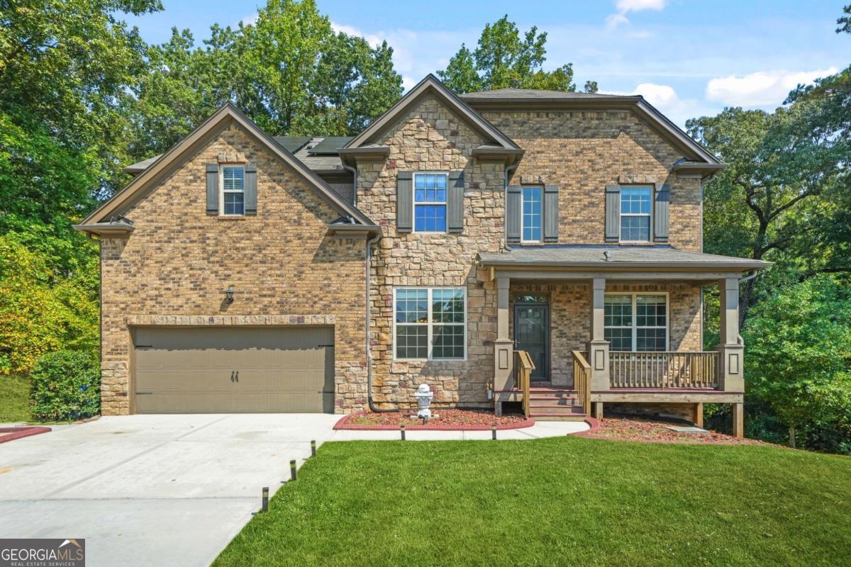 If you've been searching for a Move-in Ready home that offers size, convenience, and flexibility, this is it. Built in 2019, this immaculate 7-bedroom, 4-bathroom beauty located in the Wolf Creek Chase neighborhood is what you've been waiting for. Step inside the impressive two-story foyer and you're immediately greeted by gleaming Engineered hardwood floors, den or home office, and a dining room with coffered ceilings and elegant trim details. The gourmet kitchen with granite counters, has sleek white cabinetry, a bold backsplash, stainless steel appliances, and double ovens. It opens directly to the family room, where a cozy fireplace and built-ins make the perfect backdrop for gatherings. Upstairs, the oversized primary suite feels like a private retreat. Enjoy a fireside sitting area, spa-inspired bath with a soaking tub and walk-in shower, dual vanities, and an expansive closet. Secondary bedrooms are spacious and versatile, with plenty of room for guests, kids, or a home office. Just wait until you see the fully finished basement with its own kitchen, living space, laundry room, additional 2 bedrooms, and private entry. Perfect for multigenerational living, an in-law suite, or even rental income potential. Out back, a large deck overlooks your private wooded yard ideal for entertaining, grilling, or simply relaxing. All of this is set in a vibrant clubhouse community zoned for the highly sought-after Westlake School District. Conveniently located minutes from the Wolf Creek Amphitheater, Wolf Creek Golf Course, Camp Creek Marketplace, Hartsfield-Jackson Airport, and major highways. You'll enjoy easy access to shopping, dining, and downtown Atlanta. This rare find combines beauty, space, and practicality in one perfect package. Don't miss your chance. Schedule your tour today!