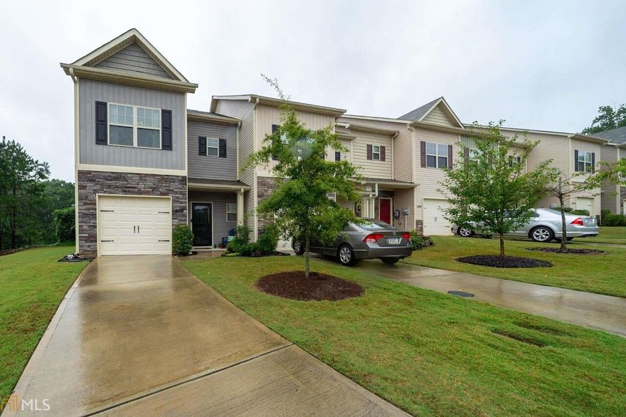 You will want to see this adorable town home with mahogany hardwood floors on main. Kitchen features Stained cabinets, granite countertops, and Stainless appliances. Kitchen is open to Family room and dining area. Upstairs 3 nice size bedrooms and 2 full baths. One of the secondary bedrooms features paneling.  Patio looks out over private area....home does not back to any other units. Ridge Mill Subdivision features a pool and HOA fees include trash, exterior maintenance and termite coverage. Highly sought after Cherokee County Schools! Close to shopping, dining and I75  HIGHEST AND BEST BY 9-21 at 4:00 PM