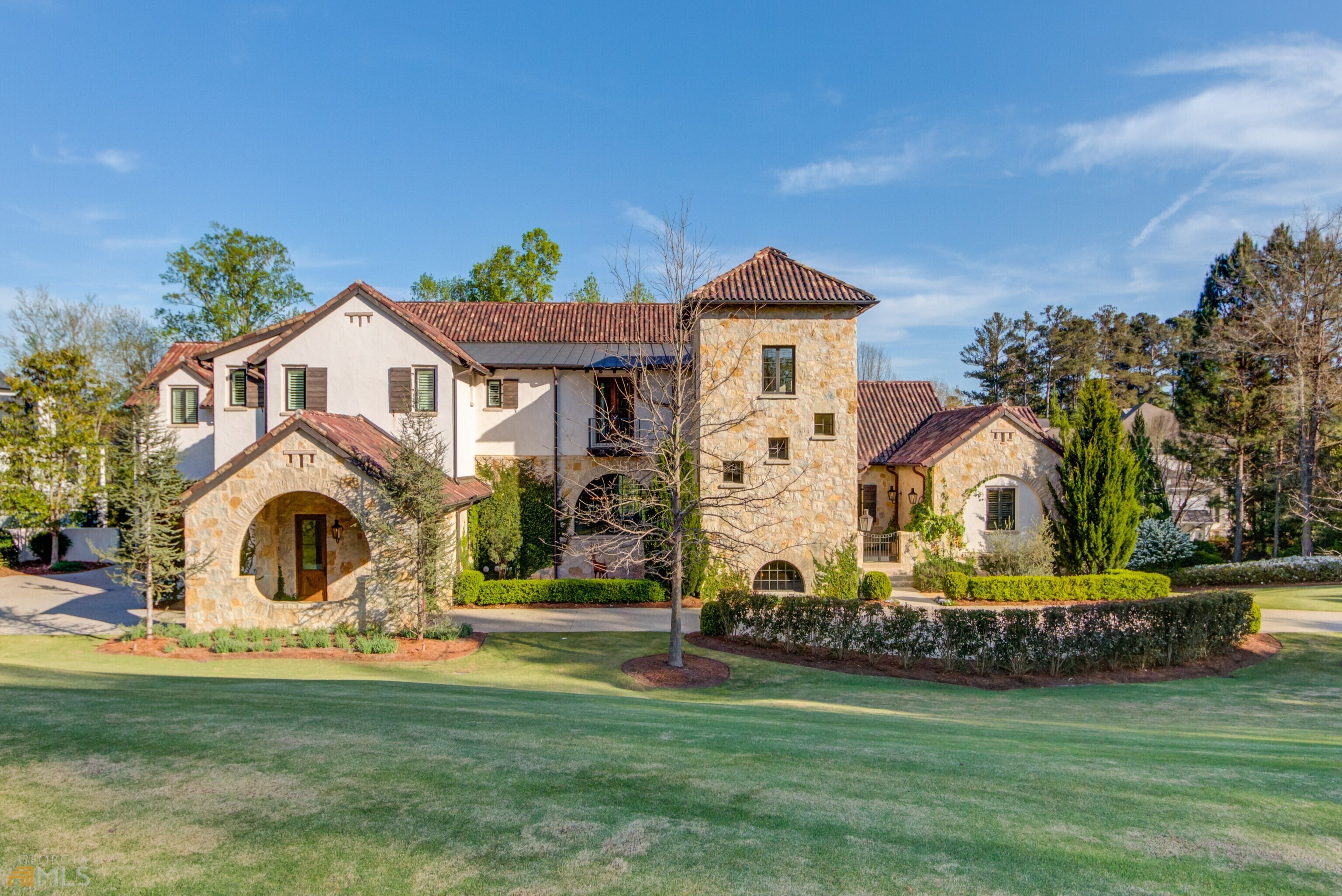 Mediterranean masterpiece in The River Club is a true labor of love with no detail overlooked. With Italian, French and Napa influences, this home has been featured in magazines Construction by Capitella Homes and designed by TS Adams to make sure every detail was true to study. Highlight of some of these details include the Tower, the placement size and style of windows, the extra depth of the walls and window wells, the aggregate driveway and the custom chimney caps. In addition to amazing details, the home boasts 6 bedrooms with the Primary Suite on Main. Main Kitchen with brick barrel vault ceiling with exposed beams, custom vent hood and cabinetry with 12' island. Prep kitchen tucked away with Subzero refrigerator and freezer, Wolf microwave and oven,Bosch dishwasher, open shelving and a pass through window to the grilling deck. The Formal Dining Room is highlighted by 1000 bottle temperature controlled wine cellar. Herring bone pattern in fumed oiled finished hardwood flooring mix with Greek limestone beautifully to allow the use of Nano doors to bring the outside in for maximum enjoyment. Upstairs boasts 4 ensuite bedrooms and Family Retreat/Club Room. Elevator service to all three floors. The terrace is level is full of light and all the same details you would hope for! Concrete bar with full appliances, a conversation area, a large media room for gathering, a home gym with rubber flooring, pool/spa bath with sauna, and luxurious guest suite. Gracious entertaining is made easy with additional panoramic doors opening to poolside. All landscaping selections were studied to be in keeping with the architecture with an Olive Tree right outside the front courtyard entrance. Did I mention the "Secret Garden"?