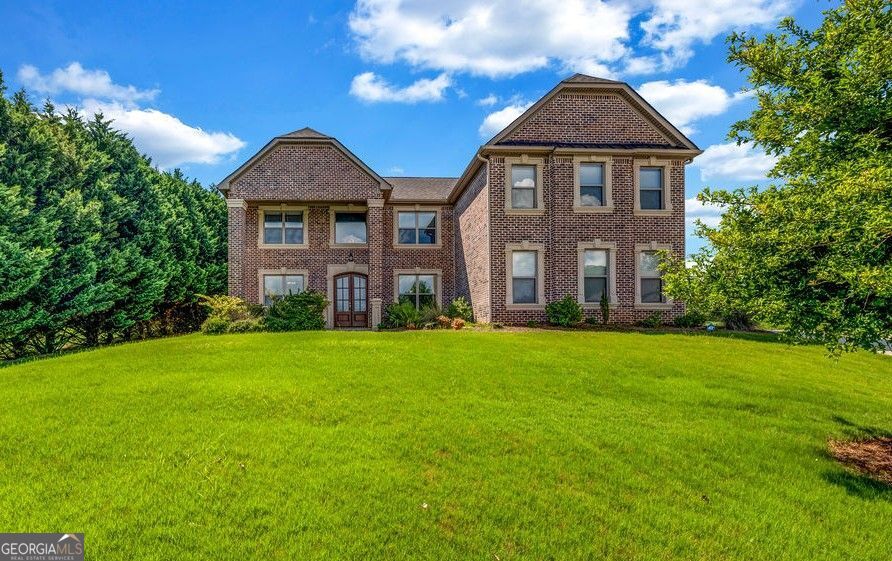 Stunning affordable luxury home in sought after Pointe Royal Subdivision in Conyers. Features open family room concept, 5 bedrooms/5.5 bathrooms, hardwood floors throughout. No carpet. Large chefs' kitchen with oversized island. All appliances remain. Junior suite on main floor, oversized laundry room, upper lever bonus/flex room perfect for media room, oversized owners suite with sitting room and fireplace. Owners' spa bathroom with large double jetted shower, oversized walk in dressing room/closet. Each guest bedroom has its own ensuite bathroom. Large outdoor rear patio comes with hot tub and patio furniture. Home is equipped with a chair lift. Chair lift can be removed if not needed. All mounted TVs, washer/dryer, ring doorbell are included with the sale of the home and serviced by 2 50-gallon hot water heaters. 3 car garage, 4-sided brick, approx. 4400 sq.ft. of living space make on a half-acre lot in a cul-de-sac makes this one a perfect 10. Easy to show.