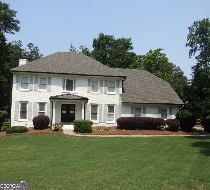 Every inch of this stunning home has been thoughtfully renovated with both style and functionality in mind. From the brand-new roof to the beautifully reimagined interiors, no detail has been overlooked. Step onto the charming front porch-now covered and finished with a durable metal roof-and enter a home where modern updates meet classic craftsmanship. Inside, you'll find custom woodwork on the walls, new stair treads with elegant iron spindles, and a bright, refreshed living room where dated paneling has been removed and stylish new countertops added to the built-ins. The heart of the home is a completely reconfigured, open-concept kitchen that now flows seamlessly into the living and dining spaces. It boasts brand-new cabinets, high-end appliances, stunning countertops, a designer backsplash, and a custom pass-through window that connects to the showstopping back porch. The mudroom enhances everyday living with a custom built in dog kennel, offering a stylish, functional solution for pet owners. The expansive, covered back porch is an entertainer's dream, featuring a stone fireplace, a warm wood ceiling, and views of one of the largest lots in the subdivision. Over 100 trees were removed to create a lush, fenced-in backyard-perfect for outdoor play and relaxation. There is plenty of room to add a custom pool to complete the oasis in the backyard. Even better, the property backs up to wooded acreage, providing a natural backdrop where deer and wild turkey are frequently seen. Upstairs, all bedrooms and bathrooms have been tastefully renovated with high-end finishes, and the laundry room has been relocated upstairs for added convenience. The full basement adds even more value with a bathroom, office space, ample storage, and a dedicated workshop beneath the porch. This truly move-in-ready home offers modern living with timeless appeal. It's one you must see to believe! Nestled in a timeless, established neighborhood known for its mature trees, spacious lots, and beautifully maintained homes and yards, this property offers rare charm and character that's increasingly hard to find in newer developments. Located in a highly sought-after school district, this home combines luxury, comfort, and convenience in one exceptional package. It's truly move-in ready and a must-see!