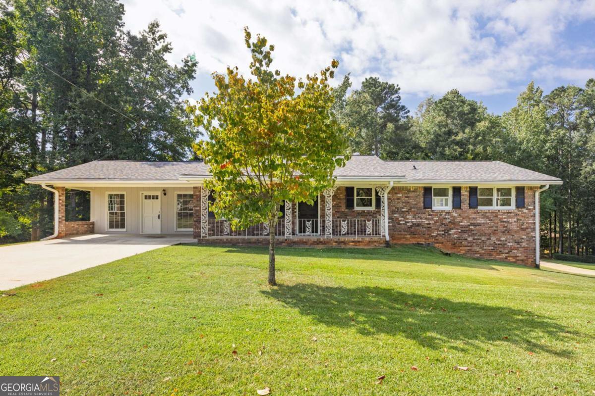 Timeless Charm Meets Modern Comfort in this Newly Renovated Brick Ranch! Discover the perfect blend of classic style and contemporary updates in this beautifully renovated brick home. Set on a generous lot, the freshly painted exterior and inviting covered front porch offer exceptional curb appeal. Step inside and be greeted by a sun-drenched living room where gleaming hardwood floors flow seamlessly throughout the main level. At the heart of the room, a cozy fireplace promises warm gatherings on cool evenings. The renovation shines in the details, with two tastefully updated bathrooms showcasing modern fixtures and finishes. The heart of the home, the kitchen, presents a warm and functional space, offering ample wooden cabinetry, a double sink beneath a window looking out into the expansive backyard, and granite countertops ready for your culinary adventures. The full, unfinished basement is a sprawling blank canvas ready to be transformed into your dream media room, personal gym, or expansive workshop. Your living space extends outdoors to a large, private backyard complete with a spacious deck, perfect for summer barbecues and entertaining friends. Location is paramount, and this home delivers with effortless access to major highways, placing premier shopping, dining, and entertainment just a short drive away. With significant updates already completed, this move-in-ready gem is waiting to welcome you home. Schedule your private tour today!