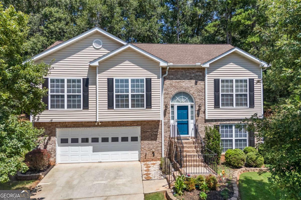 Beautifully Remodeled and Move-In Ready This stunning home has been thoughtfully updated with details and finishes you won't find in other homes nearby. As you step inside the main level, you'll be welcomed by gleaming hardwood floors, a vaulted ceiling, a wood-burning fireplace with slate surround, and an upgraded sliding glass door that opens to the deck. The fully remodeled galley kitchen showcases quartz countertops, brand-new cabinetry, stainless steel appliances-including a smooth-top, self-cleaning range, microwave, and Bosch dishwasher-plus new flooring for a modern, polished look. The newer sliding glass door leads to the stained deck that offers the perfect spot for morning coffee, afternoon lemonade, or grilling with friends. The great room flows seamlessly into the bedroom wing. Two secondary bedrooms feature double windows, new carpet, and ceiling fans. The hall bath has been completely refreshed with new shiplap and tile flooring, and features a single vanity and tub/shower combination. The spacious primary suite boasts a tray ceiling, walk-in closet, and plush new carpet. Its luxurious bath includes a tiled step-in shower, double vanity, shiplap accent wall, and upgraded tile flooring. The lower level adds flexibility with a private bedroom featuring new carpet and a ceiling fan, a full bath with step-in shower, and a versatile den/playroom perfect for TV, games, or family gatherings. Access the patio through the door from den. The laundry closet is located in the hallway and offers shelving for storage. Additional conveniences include an under-stair closet, a two-car garage with sink and work space, and a climate controlled storage room ideal for an extra refrigerator, freezer, or household essentials. Notable updates include: Roof replaced (2018) Water heater (2019) Dual-zone HVAC system with programmable thermostats; motor, capacitor, dampers, and condenser all replaced and serviced regularly by Stanfield HVAC Company. Replaced garage door springs with transferable warranty Updated lighting fixtures throughout New doorknobs and hinges on every door Every major system and detail has been upgraded, making this home completely move-in ready. All it needs is its new owner. Located within 10 minutes of downtown Athens GA and University of Georgia.