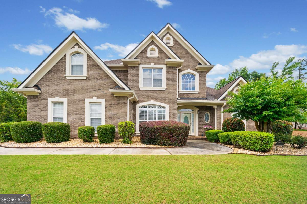 Located in the well sought after St Remy community, this four-sided brick home with circular driveway is just what you are looking for! The manicured landscaping and meticulously maintained lots throughout the neighborhood create a picturesque and serene environment. The open floor plan seamlessly flows between the living areas, allowing for comfortable everyday living and effortless hosting. This home features four spacious bedrooms, two and a half baths, with the owner's suite situated on the main level. Upon entry you will find a separate formal dining room and half bath on your path to the two-story family room. With ample size the family room sits right off the kitchen with it open floor plan, featuring the keeping room, eat-in area, counter height bar top, two pantry closets, granite counter tops, stainless steel appliances, hardwood floors, and the laundry room. Also located on the main level of the home is the owner's suite featuring a lovely sitting area and en-suite that has separate shower, jetted tub, and double vanities. You can also step out to the manicured lawn and patio area on this level of the property. Upstairs you will find three generously sized secondary bedrooms that offer flexibility in accommodating guests or providing dedicated home office or hobby spaces. The secondary bedrooms are accompanied with a full Jack and Jill style bathroom. This swim/tennis community provides opportunities for recreation, leisure, and socializing. The combination of the home's features, proximity to expressways, shopping, and restaurants all make this property an appealing choice.