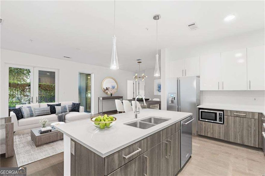 Brand new luxury condominiums in the heart of Midtown! Ready for immediate closings. J5 offers the ultimate in Intown living: quality construction, convenient location, unmatched service, and amenities. This 2nd-floor residence is an oasis in the heart of Midtown.  This 2-bedroom/2-bath home is a private corner home that has a view of the pool.  With no shared walls and a split floorplan with 10' ceilings, enjoy an open-concept living, dining, and kitchen area. Access to all Midtown has to offer just steps from your front door, J5 is setting the standard for luxurious Midtown living! All homes feature bright, open entertaining areas, wide plank hardwood flooring, stainless steel KitchenAid appliance packages with gas cooking, and quartz countertops and islands. Unwind on your private balcony or pop down to one of two clubrooms for fireside chats with neighbors. Soak up the sun next to the saltwater pool or head over to the Garden Courtyard to pick fresh herbs for your chef-inspired dinner!  24-hour concierge, state-of-the-art fitness center, pet spa, and a rooftop open-air lounge.