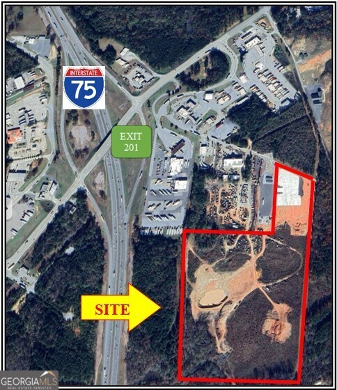 Approximately 45 acres of land near Exit 201 at I-75 with new, concrete-paved truck parking facility on site (50 existing spaces and expandable).  Rare M-2, Heavy Industrial zoning on Butts County portion!!  Lamar County portion zoned Highway Commercial but could be changed.  Fantastic location for distribution or manufacturing. All utilities available.  Water detention facility on site. Convenient to three truck stops and full interstate interchange.  Within one day drive to Miami!  Half day drive to Port of Savannah.  Convenient to Hartsfield-Jackson Atlanta International Airport!