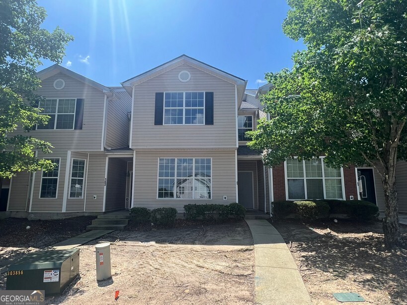 This spacious 4 bedroom, 2.5 bath townhome offers comfort, convenience, and recent updates-just minutes from Olde Town Conyers, I-20, Piedmont Rockdale Hospital, schools, shopping, dining, and entertainment. The main level features an open-concept layout with a large family room, kitchen with stainless steel appliances, breakfast area, separate dining room, laundry closet, and a convenient half bath. Upstairs, the master suite includes a walk-in closet and a private bath with a tub/shower combo. Three additional guest bedrooms and a full hall bath provide plenty of space for family, guests, or a home office. Additional highlights include a 2-car parking pad in the rear, an updated deck, new LVP flooring on the entire main level and in all bathrooms, new carpet in the bedrooms, fresh paint throughout and a new class 3 architectural shingle roof with a transferrable warranty. This move-in ready townhome is perfect for low-maintenance living and is located in a prime location.