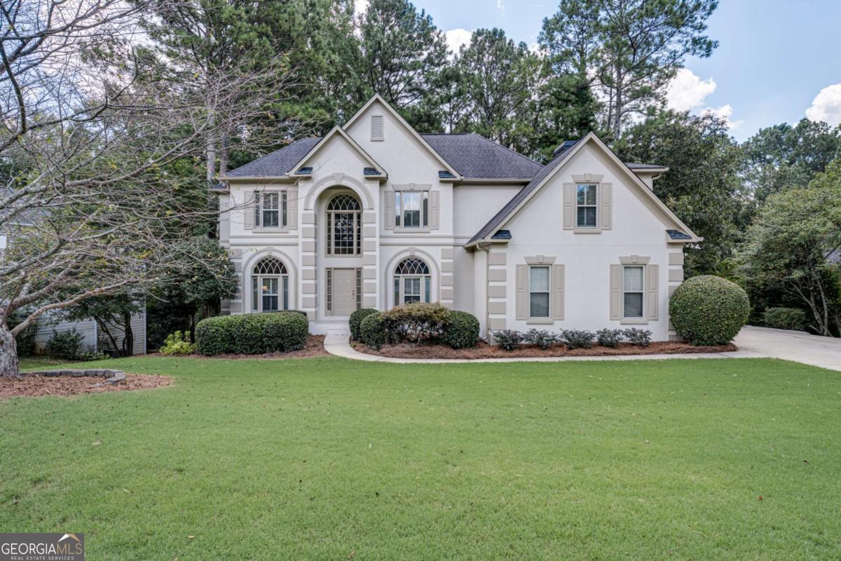Welcome to Your Exquisite Dream Home in Olde Atlanta Club! Step into a world of elegance and comfort in this breathtaking 5-bedroom, 4-bathroom masterpiece, perfectly situated on the 8th fairway of one of Forsyth County's most coveted private golf course communities. Renowned for its outstanding Lambert High School, this home is not just a residence; it's a lifestyle. As you enter, you'll be greeted by a fresh, vibrant ambiance, thanks to the newly painted interiors and exteriors. The heart of this home is the stunningly renovated kitchen, where culinary dreams come to life. Adorned with chic white cabinets, luxurious quartz countertops, and a stylish backsplash, this space is both functional and fabulous. The center island and breakfast bar invite casual gatherings, while the cozy eat-in area overlooks a warm and inviting family room. Imagine cozy evenings by the stacked stone fireplace, surrounded by built-in bookcases that add character and charm. A full wall of windows bathes the room in natural light, offering great seasonal views of the lush golf course, creating a serene backdrop for your family's cherished moments. Gorgeous real hardwood floors flow seamlessly throughout the main level, stairs and upper hall enhancing the home's sophisticated appeal. Step outside onto the oversized deck, where you can grill and unwind. The separate dining room and elegant living room, featuring soaring vaulted ceilings in the living room, provide the perfect setting for formal gatherings or intimate family dinners. A main-level bath with a full walk-in shower adds convenience and luxury. Ascend the stunning staircase adorned with iron rails to discover the opulent master suite, a true retreat. The full wall of windows also has lovely seasonal views of the Golf Course. The spa-like master bath is a sanctuary of relaxation, boasting his and her vanities, a sumptuous sunken tub, and a spacious walk-in shower, complemented by a generous master closet that fulfills all your storage needs. Two additional spacious bedrooms, a large bonus room, and another full bath ensure ample space for family and guests. The fully finished basement is a showstopper, featuring a stylish full bar, a movie theater room with surround sound, and a vast open area perfect for a pool table or game nights. This level also includes a fifth bedroom and a full bath, with a walkout to a peaceful patio and a beautifully wooded backyard for great privacy and wonderful seasonal view of the Golf Course, ideal for outdoor gatherings. Updated windows through out the home and custom plantation shutters on the entire front of the home, Olde Atlanta Club is not just a neighborhood; it's a vibrant community filled with outstanding amenities that cater to every lifestyle. Members can enjoy leisurely days on the golf course, dine at the on-site restaurant. OAC amenities boast two sparkling pools, a splash pad, and a playground, your children will thrive in this active environment, especially as part of the community swim team. Engage in friendly matches on the tennis courts or join one of the many tennis or pickle balls teams or for men, women, and mixed play, and host unforgettable gatherings in the beautiful clubhouse. Don't miss your chance to embrace the extraordinary lifestyle this exceptional home offers. Your dream home awaits!