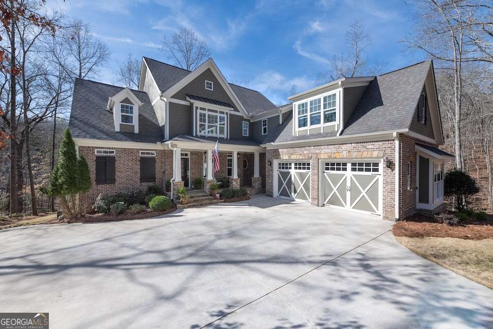 **JUST STEPS AWAY FROM THE WATER! The lake is just out your backdoor!** This CUSTOM-BUILT home has all the LUXURY, THOUGHTFUL DETAILS you would expect off the lake, but includes LAKE LIFE at an UNBEATABLE PRICE.**There aren't many turn-key homes so close to the water in this price range,** The light-filled kitchen is a CHEF'S DREAM and is equipped with SOFT-CLOSE CABINETS and stainless steel appliances and is open to the 11 FOOT-CEILING FAMILY ROOM. Both gathering spaces, as well as the PRIMARY SUITE ON THE MAIN FLOOR, have LAKE VIEWS to enjoy all day. Even at night, lights reflect off the water for a serene ambiance as you wind down. The home is built away from other homes in the CULDESAC, ensuring a feeling of PRIVACY and seclusion. LAUNCH YOUR KAYAK right out the back door, FISH over 350 feet of UNOBSTRUCTED SHORELINE, or make the SHORT EASY WALK to your DEEDED, PERSONAL BOAT SLIP with HYDROHOIST on the COMMUNITY DOCK. (This is ONE OF ONLY TWO HOMES in Lighthouse Harbor with DIRECT ACCESS to the dock via a PRIVATE TRAIL. Other dock owners must use a shared path from elsewhere in the neighborhood.) The location of the dock offers CALM WATER, with MINIMAL BOAT TRAFFIC AND LITTLE WAKE-perfect for SAFE SWIMMING, FLOATING, and keeping your boat protected from wave damage. The dock also has SECURITY CAMERAS and is treated monthly with SPIDER AWAY. There are plenty of options for entertainment for your friends and family, from two SPACIOUS PORCHES where you can watch HERONS land on the lake, see DEER, and listen to the BABBLING BROOK in the woods. Entertainment spaces within the home also include a MOVIE ROOM and a huge, sunlit, STUBBED-OUT TERRACE LEVEL! The HIGH-CEILING TERRACE LEVEL BASEMENT enhances the home's spacious feel and provides ample opportunity for expansion. And don't forget the NEIGHBORHOOD POOL and CLUBHOUSE just around the corner from Nantucket Cove. Want a private pool in your own backyard? We have confirmed there is room! In addition to LARGE BEDROOMS throughout the house, there is a NANNY'S QUARTERS or ADDITIONAL FLEX SPACE with SECOND LAUNDRY UPSTAIRS. DON'T MISS YOUR CHANCE TO OWN THIS GEM! Be sure to watch the virtual video tour!