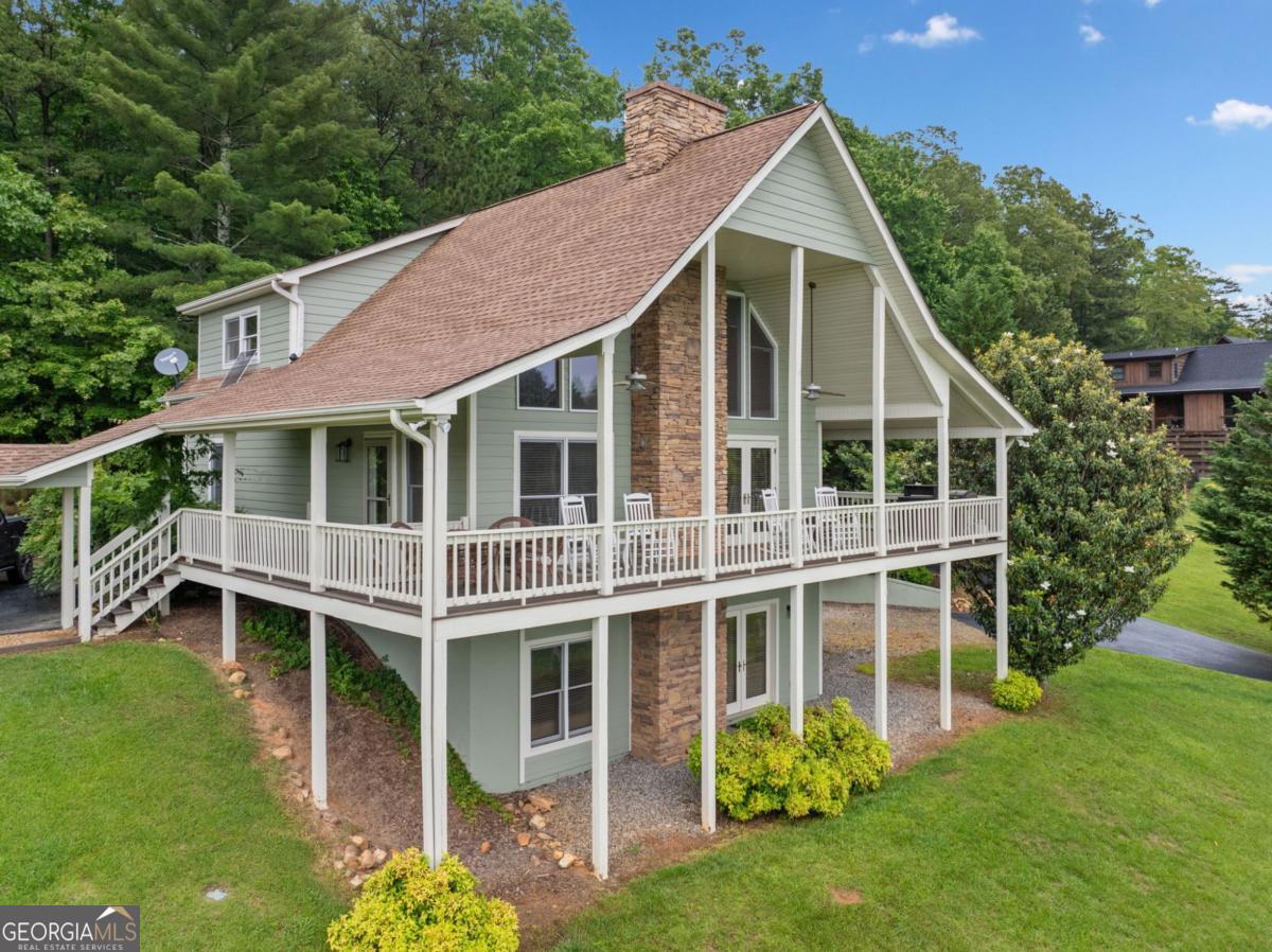 Welcome to your dream getaway in the scenic foothills of the Blue Ridge Mountains! This beautifully updated 4-bedroom, 3-bath mountain cabin offers the perfect blend of rustic charm and modern comfort-ideal as a full-time residence, weekend escape, or turnkey vacation rental. Soaring vaulted ceilings, expansive windows, and an open-concept design flood the home with natural light and frame the unobstructed mountain views that will take your breath away. The spacious great room features a cozy stone fireplace and double French doors leading to a wraparound covered deck-perfect for sipping morning coffee or evening wine while soaking in the scenery. The kitchen is made for entertaining with stainless steel appliances, a generous breakfast island, and plenty of prep space. Recent upgrades include all-new flooring, fresh interior/exterior paint, new bathroom fixtures, a whole-home water filtration system, and a relocated upstairs laundry for added convenience. The fully finished daylight basement offers even more room to spread out, with a newly completed game room, summer kitchen, additional bedroom, and full bath-ideal for hosting guests or creating a private suite. Situated on a gently sloping 1.02-acre lot, there's plenty of space for kids and pets to roam, and the community-stocked pond invites lazy afternoons of fishing or relaxing by the water. A paved driveway, lower parking pad, and detached 2-car garage provide ample room for parking and all your outdoor gear. Additional perks include being fully furnished and move-in ready, pet-friendly, located just minutes from Downtown Blue Ridge, and offering a strong vacation rental history for those seeking an income-producing property. Whether you're looking for a peaceful mountain escape or a smart investment property, this one checks all the boxes.