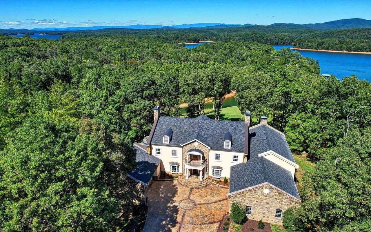 Private gated Equestrian/Lakefront Estate in the North Georgia Mountains, 65 Acres with approx 1000 feet of Lake Nottely frontage, between Blairsville and Blue Ridge. 5 stall Timber frame barn with kitchen, bath and riding arena. The luxurious French Country home features 6 bedrooms and 5+ baths, 4 car garage, 2 sty living room, elegant spiral staircase, banquet dining room, massive great room and elevator. Gorgeous property, very private with pastures, wooded areas, trails, orchards and metal equipment building. New boat dock. Many smart home features. Custom hot tub overlooking beautiful Lake and Mountain views.