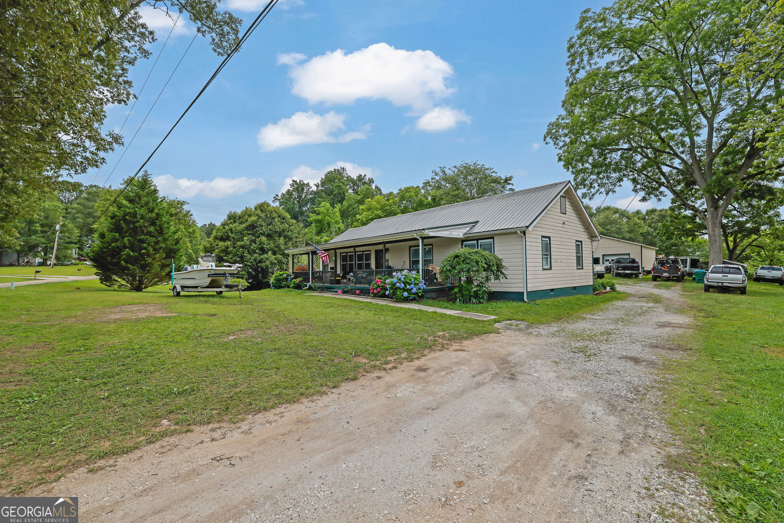 Discover this lovingly maintained 1952 gem on over 2 private acres. Features 4 bedrooms & 2 beautifully appointed custom bathrooms. Enjoy peace of mind with a durable metal roof and the ease of brand-new appliances. Detached 2-car garage & sprawling lot complete this picture-perfect ranch home.