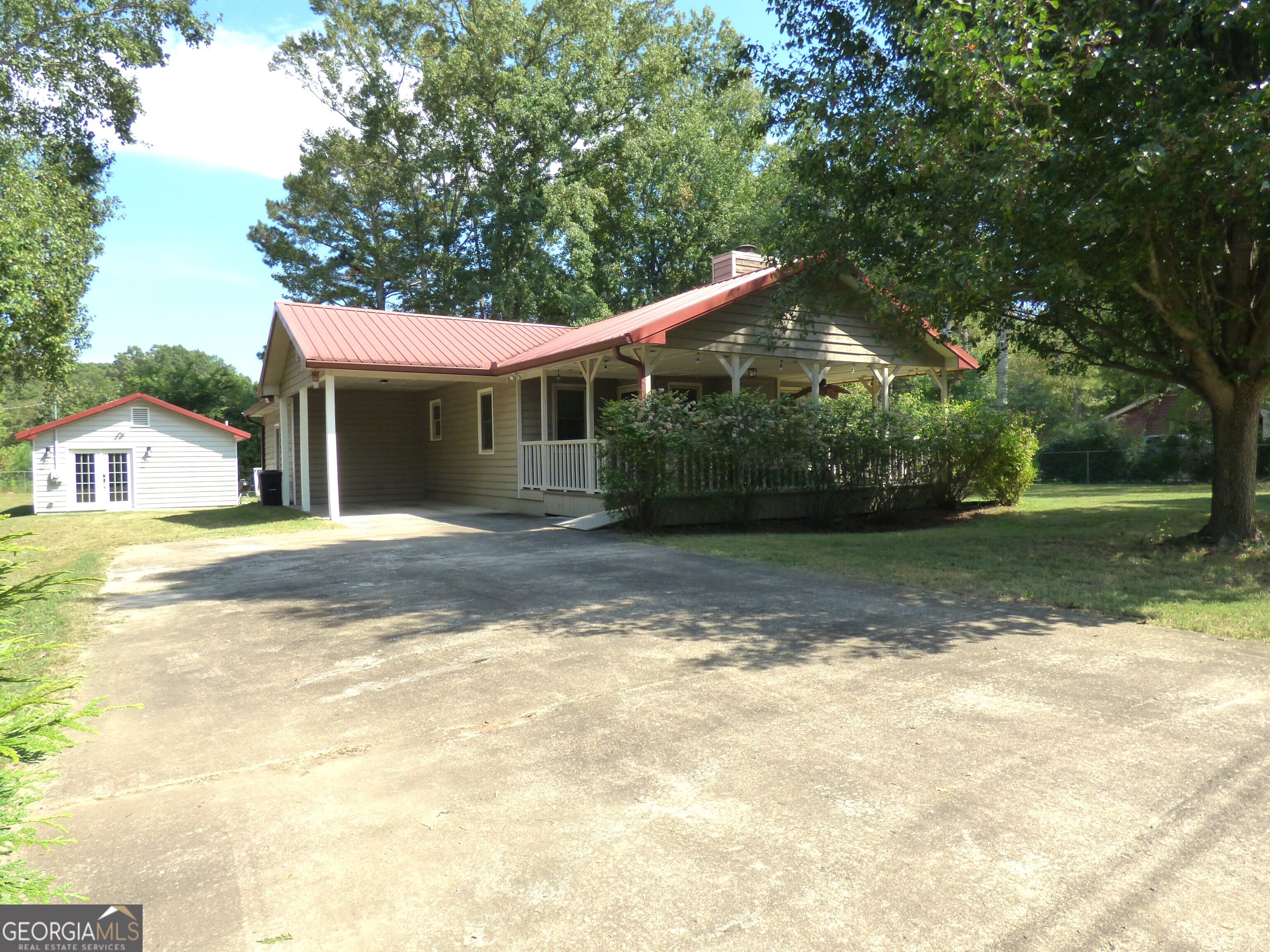 Escape to this charming 2-bedroom, 2-bath cottage nestled in an established, tree-lined neighborhood with no HOA. Enjoy quiet moments on the huge front porch with an accessibility ramp or on the rear screened porch and deck. The cottage features a durable metal roof, cement siding, and a cozy fireplace. Inside, LVP flooring and ceiling fans enhance comfort throughout, no carpet here! A new HVAC and a freshly serviced septic system provide peace of mind. Don't miss the detached 620 sqft, 1-bedroom, 1 bath apartment with a kitchen that offers additional living space for relatives or rental income. Walk to Adairsville High or Middle schools, with downtown just a short trip away. Only 1 mile from Manning Mill Park.