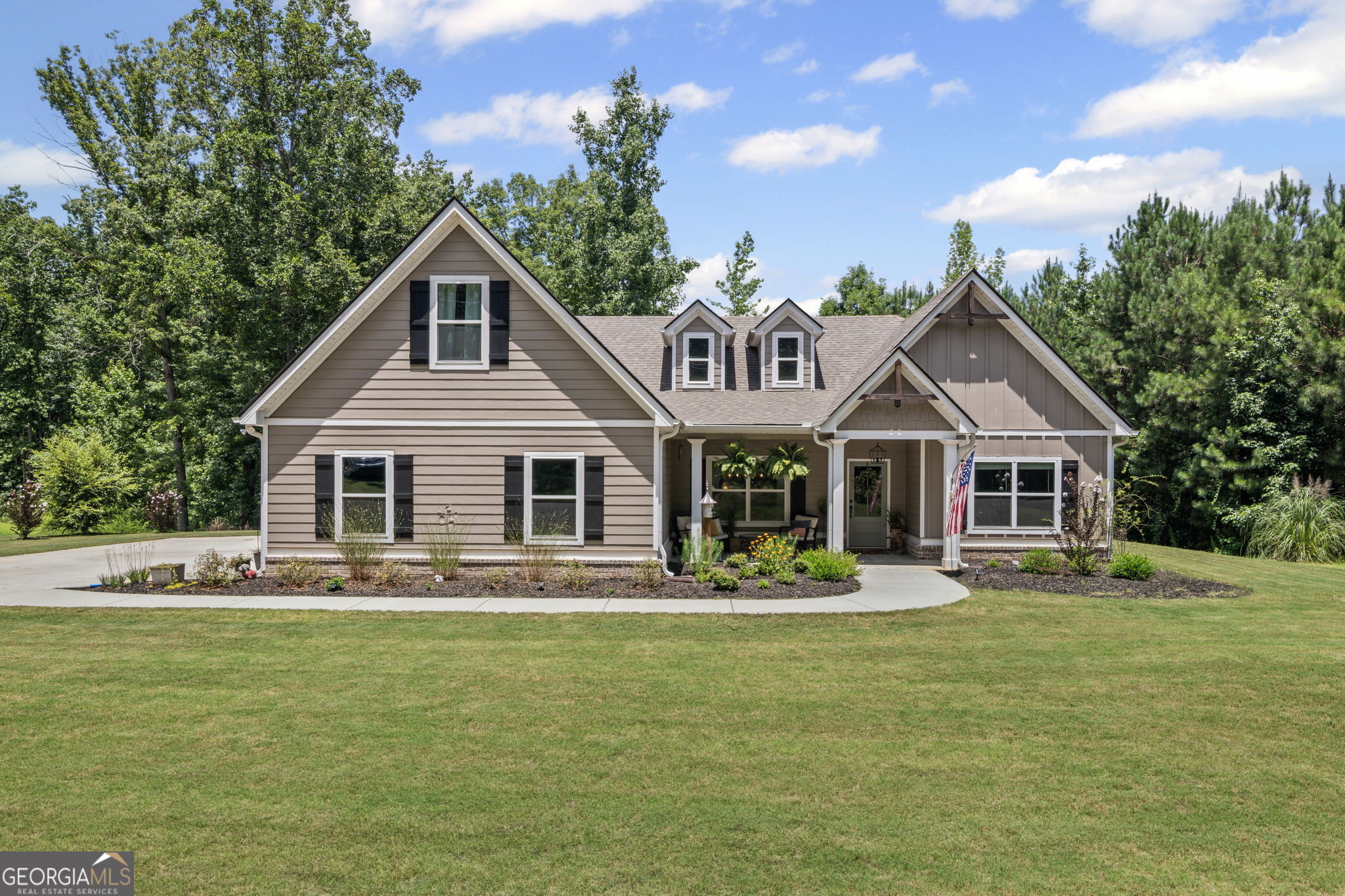 FABULOUS CRAFTSMAN STYLE HOME ON 2.5 ACRE LOT!! Open floor plan with large kitchen w/quartz countertops, tiled backsplash, stainless appliances, large quartz top island w/stainless farm sink, breakfast bar & LVP hardwood flooring. Family room is open to the kitchen w/a trey ceiling w/wood beams & LVP hardwood flooring. Vaulted keeping room w/brick surround fireplace & LVP hardwood flooring. Primary bedroom on main w/walk-in closet. Tiled primary bathroom w/quartz top double vanity, garden tub w/tiled surround, tiled shower w/framed glass. 2 Guest bedrooms on main q/tiled guest bathroom w/quartz top vanity & shower/tub. 3rd Guest bedroom upstairs w/walk-in closet & tiled guest bathroom w/quartz top vanity & shower/tub. 2 Covered porches on the back of the house overlooking private backyard. Covered front porch. Foam insulation . Split bedroom plan. Located in North Coweta County and in top rated school districts! Minutes from I-85!