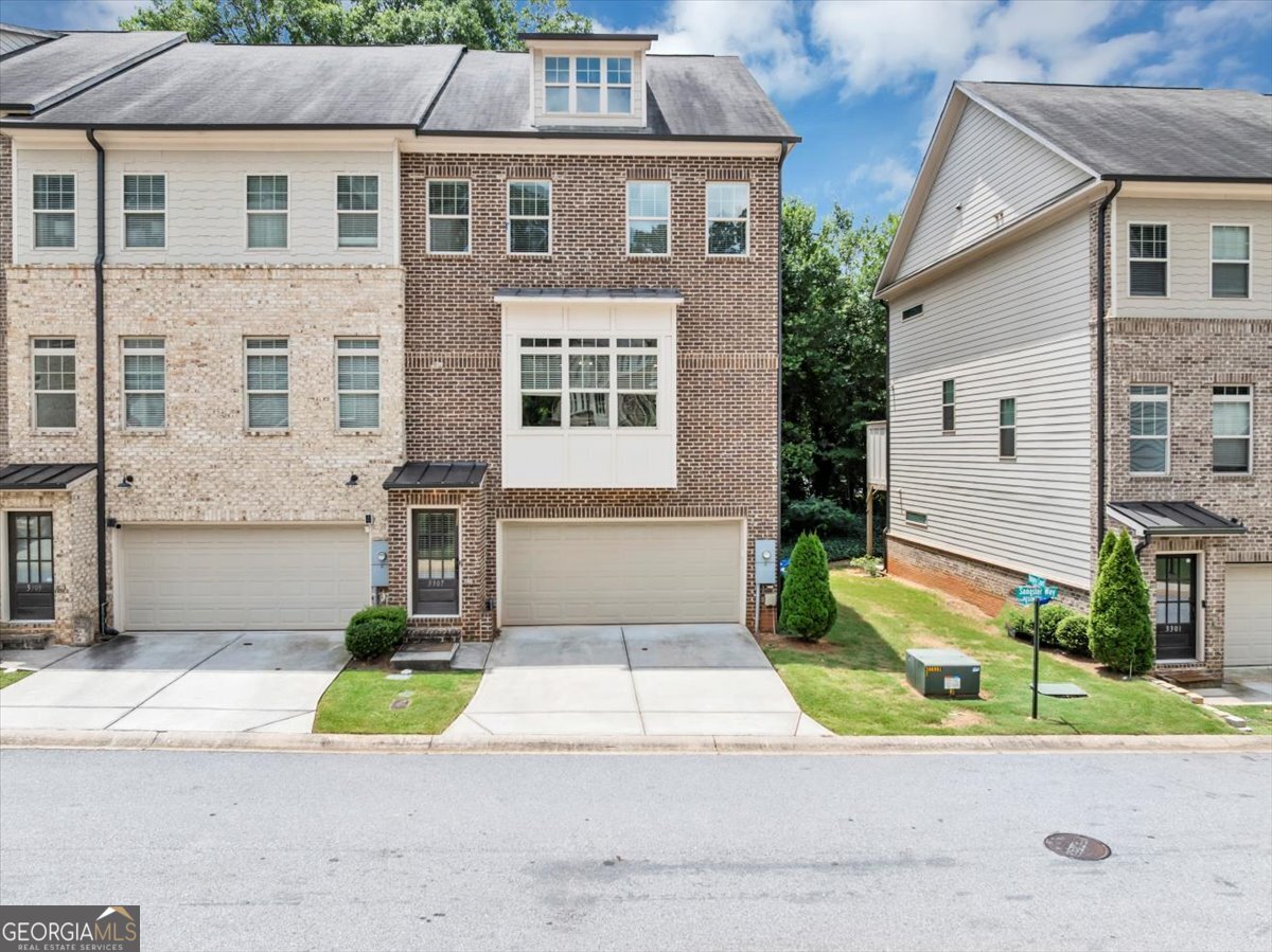 Welcome to this stunning 4 bed, 3.5 bath Decatur end-unit townhome with luxurious finishes, flexible living spaces, and an unbeatable location. Just minutes from Downtown Decatur, Whole Foods, The DeKalb Farmers Market, Emory, the CDC, East Lake Golf Course, and Hartsfield-Jackson Airport. Nestled in a gated community near Avondale Estates, the home beams with natural light across an open floorplan and showcases 10' ceilings, 5" hardwood floors throughout, crown molding, and a cozy fireplace. Enjoy the private balcony, perfect for morning coffee or an evening unwind. The chef's kitchen impresses with a massive10-ft island, stainless steel appliances, and ample storage, ideal for entertaining. Elegant custom wainscoting defines the dining space, setting a polished tone. Upstairs, the oversized primary suite boasts tray ceilings, a spa-like bathroom with soaking tub and shower, and a large walk-in closet. Two additional bedrooms and a full bath complete the upper level. The lower-level ensuite bedroom is a true bonus, curated for today's modern family. It provides flexibility to create a private guest suite for multi-generational living, a home office for remote work, a playroom, or fitness space. Connected to the 2-car garage, it's designed to adapt as your lifestyle evolves. This home qualifies and can be purchased with NO MONEY DOWN and includes a 1-year Choice Home Warranty.