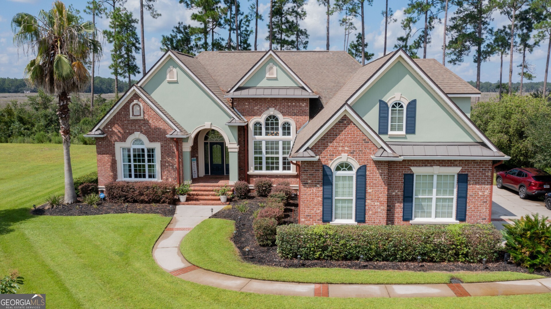 Welcome to this stunning home in the sought-after Winding River community, perfectly situated on one of the largest and most desirable lots with breathtaking marsh and water views. Nestled right on the marsh, this property captures the natural beauty of its surroundings while providing a private and serene retreat. From the moment you arrive, the curb appeal is undeniable. An extra-long driveway leads to a spacious side-entry two-car garage and also provides convenient access to the backyard. Lush, well-kept landscaping surrounds the property and is maintained with a private well system, keeping the grounds both vibrant and low-cost to maintain. Step inside to find custom woodwork and soaring ceilings that set this home apart with warmth, charm, and architectural detail. The heart of the home is the beautifully appointed kitchen, featuring a breakfast bar, ample cabinetry, and nearly all newer appliances. From there, you'll enjoy a seamless flow into the eat-in dining area and the formal dining room-perfect for both casual meals and entertaining guests. A large living room provides space for gatherings, while a separate family room offers flexibility for movie nights, a home office, or hobby space. The primary suite is a true retreat, featuring a spacious bedroom and a luxurious bathroom with a massive walk-in shower boasting dual showerheads. Secondary bedrooms are comfortably sized, while the upstairs bedroom is exceptionally large-spanning nearly the size of a second primary-with its own walk-in closet and full bathroom. This makes it ideal for guests, extended family, or a private getaway. Enjoy year-round outdoor living in the tiled, screened-in lanai, where breathtaking views of the marsh create the perfect backdrop for morning coffee, evening relaxation, or entertaining friends. Beyond the home itself, Winding River offers an exceptional lifestyle with access to a resort-style pool, fitness center, clubhouse, sports field, and scenic walking and biking trails. Ideally located, the neighborhood is close to top-rated schools, convenient shopping, and just minutes from Kings Bay Sub Base. If you're searching for a spacious home with unbeatable views, custom finishes, and a vibrant community, this property is a rare opportunity you won't want to miss.