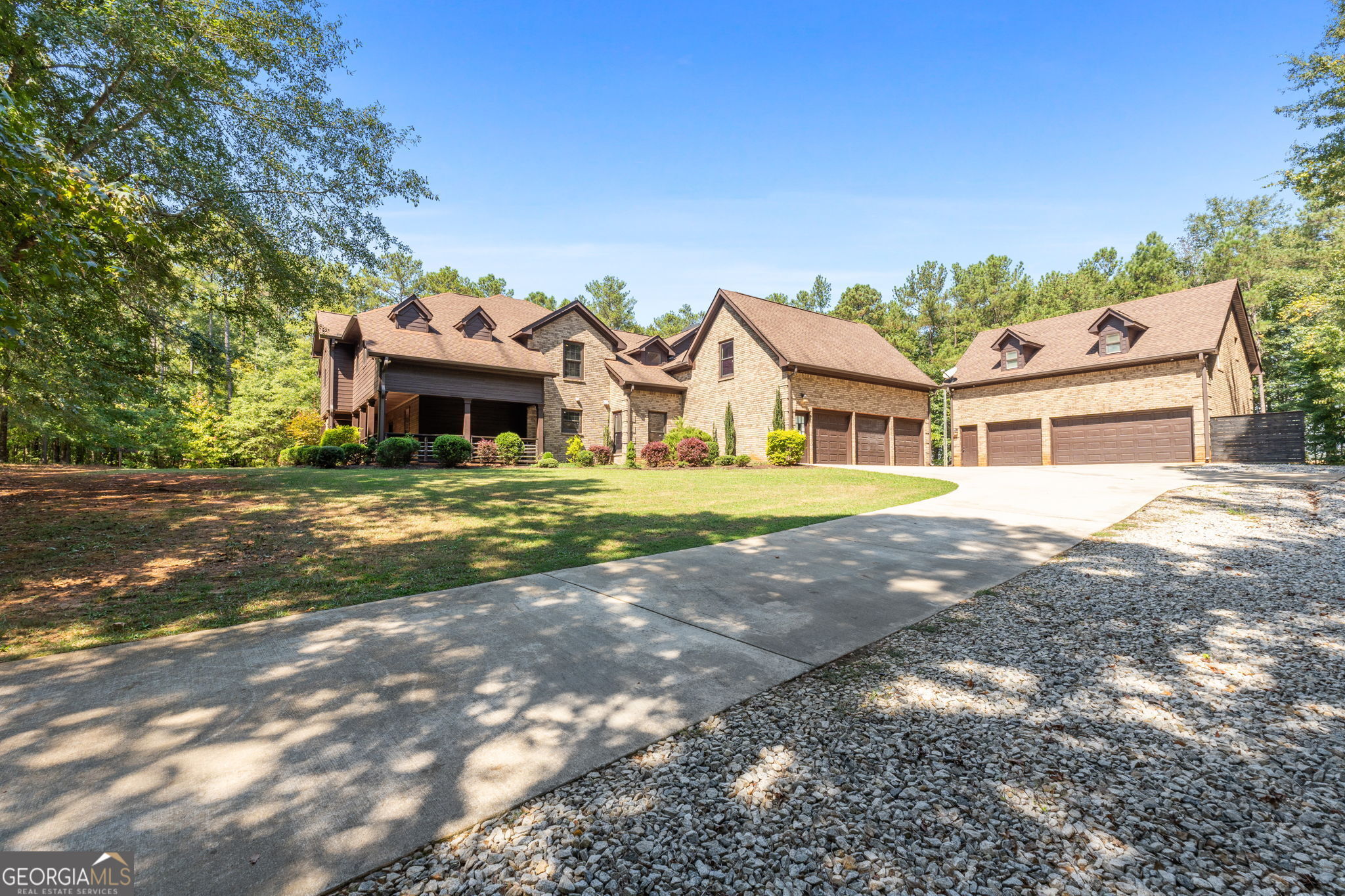 Exquisite home designed for the "Luxury meets sports enthusiast." Four sided brick home with guest home on over 3 acres with space to cover all your needs, inside and out! The main home features multiple living spaces, a chef's kitchen with butcher block, wine refrigerator, vegetable sink, breakfast bar and room, formal dining room, office, guest powder room, and state of the art recreation area. Entertainers have found their dream home with the "Fun Zone," this home provides. Indoor basketball court, pool and game room, wet bar, media room for the gamers and home theater with surround sound. Upstairs you will find six bedrooms and six full baths. Each bedroom has its very own ensuite. The owner's suite features a sitting area, dual closets, soaking tub, separate shower, built-in speaker system, and private balcony. There is a secondary master/guest suite on its private wing that is oversized & would also be a great upstairs living room/game room with wet bar area. The main home also has a three car garage with a buffer wall to secondary as a workshop attached. The back patio overlooks a large, private backyard, perfect for a future swimming pool. The guest home features a full kitchen, living room, two bedrooms and full bath. The private balcony overlooks the peaceful, quiet backyard. The guest home also has its own washer and dryer hook up and three car garage. Together this property offers a total of a 6 car garage. The builder made sure this home was built to be very energy efficient for the space it provides. There is additional space for boat/camper parking as well. The property is close to I-75, Atlanta, Macon, shops and dining. Please schedule an appointment today to view this magnificent home.