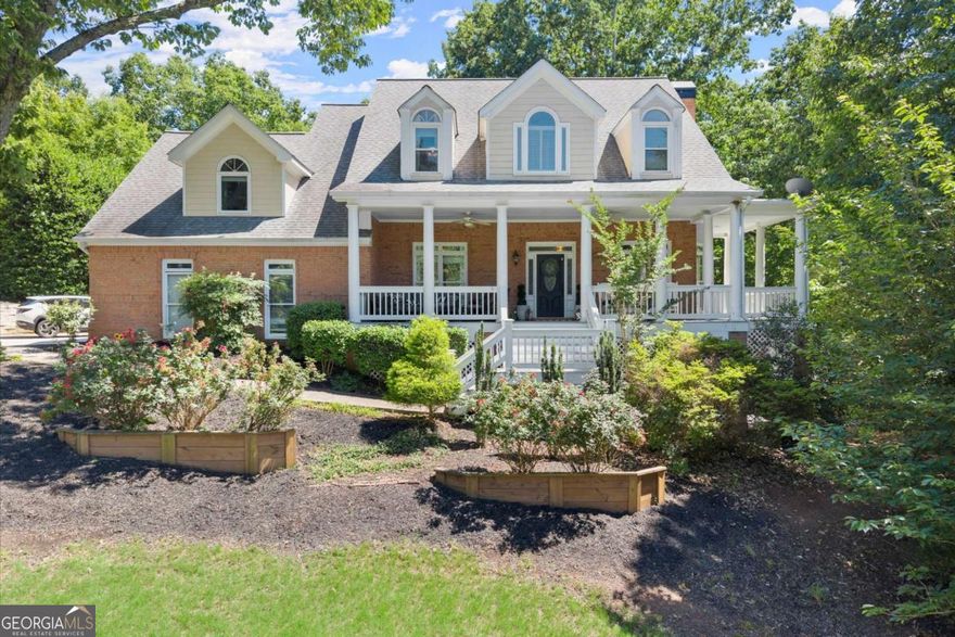 Welcome Home to 2936 Summitop Road - a private oasis your whole family can grow into!  Tucked away on a quiet, wooded lot, this spacious 5-Bedroom, 4.5-Bath home has everything you need - inside and out. From lazy Pool days to cozy movie nights, this home is built for making memories. As you walk up to the huge wrap around front porch take a moment to sit down and enjoy the view. Step inside to discover a spacious, thoughtfully designed interior where natural light pours through oversized windows, highlighting elegant finishes and timeless charm. The main level features hardwoods and new windows, large open living room and sitting room with gas fireplace and built-ins. A formal dining room (that doubles as an office now) will be perfect for holiday dinners or game nights. This kitchen is stylish AND functional with tons of cabinet space, a walk-in pantry, quartz countertops, SS appliances, gas cooking, breakfast bar, farmhouse sink and a large picture window overlooking the pool. Built-in bar with glass display cabinets, prep sink and ice maker compliments the kitchen and is perfect for entertaining. Whether you're having breakfast, dinner, doing homework or checking emails, you'll love the dining area with beautiful views of the lush landscaping, pool and deck! Upstairs, the primary suite is your personal retreat with a wall of windows overlooking the treetops, trey ceiling with beautiful crown moldings, a sitting area and a huge walk-in closet. The ensuite bath features a separate shower, double vanities and soaking tub. Three additional spacious bedrooms give everyone their own space. Two bedrooms share a Jack n Jill bath while the 3rd bedroom has an ensuite bath. Need extra space to spread out? The finished basement expands your living options! With space for a media or gaming room, storage for all your crafts and games, and fun Double Bunk Beds for sleep overs or cozy naps! Large open den is ideal for more entertaining with a 2nd gas fireplace and outdoor access. A separate bedroom is currently serving as a large closet and a separate full bath can become an in-law or a teen suite. If you love outdoor living, this yard is the ultimate backyard hangout. The secluded backyard gives you all the peace and quiet you crave with a 2 level deck - one for dining and grilling, the other for chilling! Get ready for summer fun at your own private pool with space for sunning and relaxing. Whether you're hosting a BBQ, swimming with the kids, or relaxing on the deck with a cup of coffee, this yard is a total vibe. Located in the Top Rated Lassiter High School district with easy access to parks, shops, and restaurants, this home checks all the boxes. Don't miss your chance to live your best family life in a home that truly has it all!