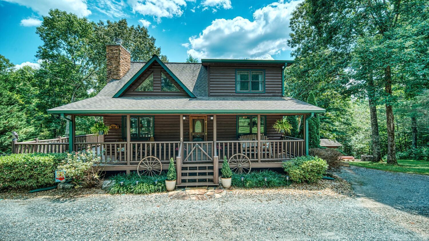 Welcome to your dream log home nestled in the picturesque town of Young Harris, Georiga.This stunning 4 bedroom, 3 bath log home is perfect blend of rustic charm and modern comfort, offering inviting living experience. Youall be captivated by the beauty of the log exterior, surrounded by nature. The detached (22x30) garage provides ample space for your vehicle. Step inside and be greeted by the warm and inviting open -concept living area. The living room boasts vaulted ceilings, a stone fireplace, and large windows for natural light. The kitchen is chefas delight, featuring modern appliances, and a breakfast bar. Adjacent to kitchen is dining area.The main level also hosts a comfortable bedroom,full bath, and laundry room. Make your way upstairs to discover master suite, bathroom and one additional bedroom. In the basement you will find large living room and second master suite. Owned by licensed realtor