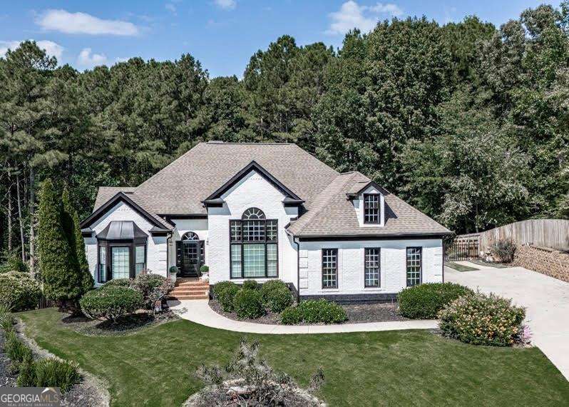Welcome to refined elegance in the coveted Governors Preserve community. This true ranch estate, perfectly set on a full, finished terrace level, has just undergone a complete exterior refresh with professional painting completed last week, all new window and door trim, and a freshly painted back deck, presenting a residence that feels brand new from the moment you arrive. Inside, you will find soaring 12-foot ceilings, including a dramatic 14-foot ceiling in the dining room, an open and flowing layout, and five beautifully appointed bedrooms with three full bathrooms. The expansive finished terrace level offers two bedrooms, a full bath, kitchenette, and generous open living and storage space-an ideal retreat for guests, multi-generational living, or an entertainer's dream space. Step outside to your private backyard sanctuary featuring a resort-style pool with a liner less than two years old, expansive deck space, a covered lounge area, and a pool house ready to be transformed into a custom bar or cabana. The freshly landscaped grounds create the perfect backdrop for outdoor entertaining and relaxation. Additional highlights include a brand-new HVAC system, fresh interior paint within the last two years, and updated bathrooms with new paint, fixtures, and mirrors. Every detail of this home has been thoughtfully curated to offer timeless luxury, turnkey convenience, and the ultimate in indoor-outdoor living.