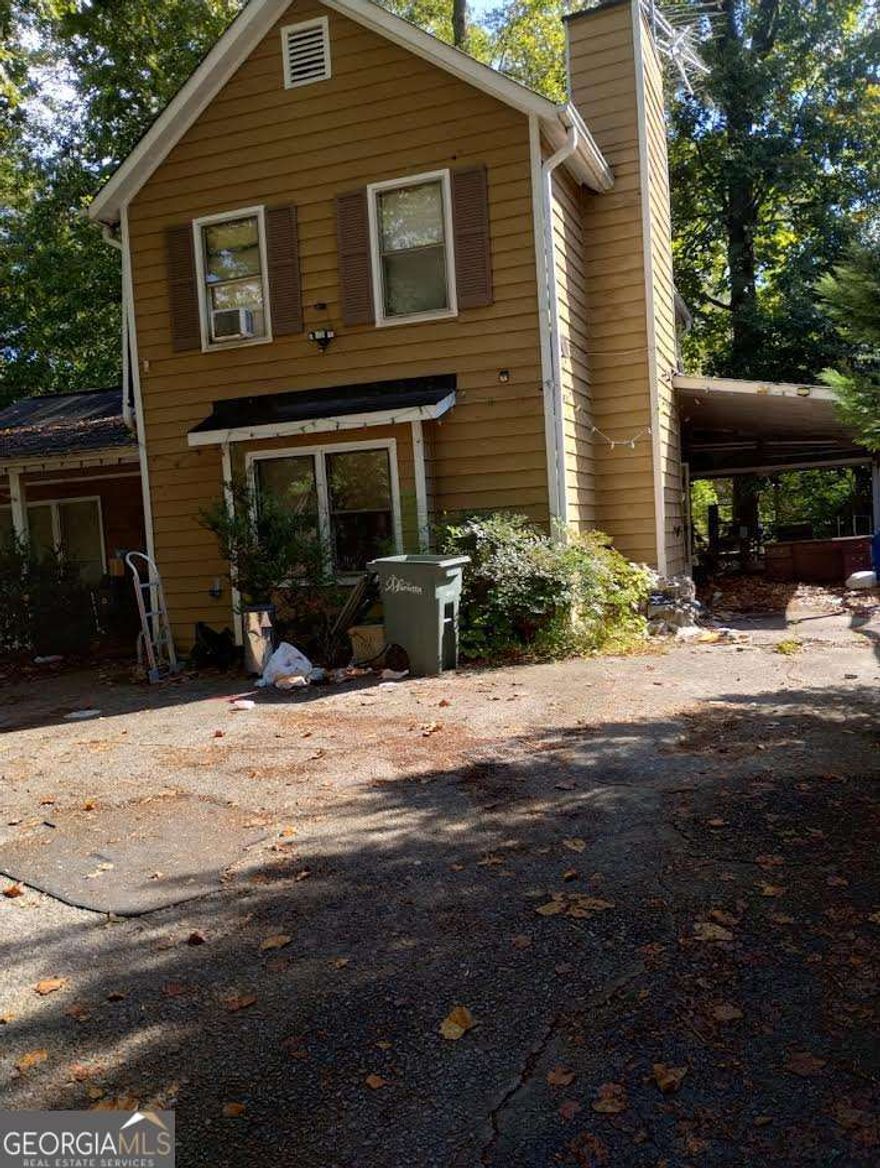 This move-in ready home is waiting for its next owner. It has solid bones and plenty of potential for someone to make it their own. The property features a carport and an enclosed porch, offering extra space to enjoy. Conveniently located less than 10 minutes from Marietta Square, you'll enjoy easy access to local shops, dining, parks, and top-rated schools. Don't miss out on this well-located home with so much to offer!