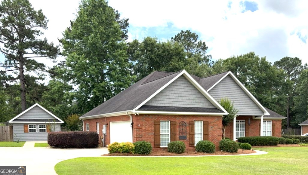 A renovated dream home in the heart of beautiful Dublin! This home was recently remodeled with new floors throughout, new trim and paint, new appliances, cabinets, countertops, kitchen island, 7 new ceiling fans and new upgraded light fixtures. This stunning all brick, one level, 3 bedroom, 2 bath home is customized with an open floor plan that's perfect for modern living and entertaining! The total heated and air-conditioned living space of this home is 2,955. The main house is 2,725 Sq. ft. and just steps away from the sun room is a separate finished 230 sq.ft. building with heat and air. Thie separate building is perfect of an office, craft room, a man cave or whatever you heart desires. When you walk through the door, the kitchen immediately captures your attention with its expansive, extra-large, 52 sq. ft., center island, a stunning focal point that offers both style and practicality. Framed by elegant cabinetry, this generous space invites you and your guest to prep, cook and serve with ease. The thoughtful layout ensures everyone has room to fellowship without getting in each other's way. Whether hosting dinner parties or casual gatherings, this kitchen is designed to be the vibrant heart of the home. This home's split-bedroom layout ensures privacy and comfort. The spacious primary suite, (13'6" x 21'3", 287 sq. ft.) features an on-suite bathroom with a tiled shower, soaker tub, custom vanity and a walk-in closet, it is your own personal retreat. The guest area, on the opposite end of the house, includes two additional bedrooms, one which provides a custom closet with an integrated dresser that optimizes both space and functionality and a full bath with shower and tub. Relax and unwind in the heated and air-conditioned sunroom, which is wrapped in gorgeous tongue and groove pine wood walls and bamboo flooring, it offers serine views of the private shaded backyard, the perfect spot for your morning coffee, reading your favorite book or an evening retreat. The large walk-in pantry provides lots of storage that is only a few steps away from the kitchen. The pantry was once a half bath, and it still has all the plumbing, it could be easily turned back into a half bath. This home is beautifully landscaped, and the entire lawn has a lawn sprinkler system in a separate water meter which allows you to water the lawn without paying extra sewage cost. This home is conveniently located to medical care, the hospital, shopping, schools and dining.