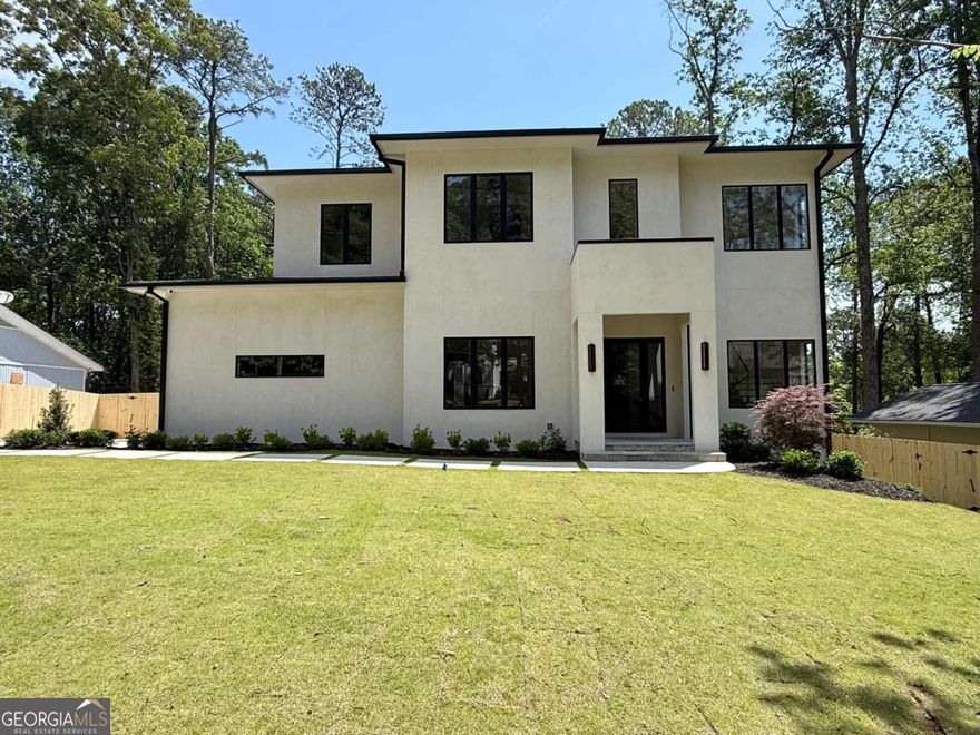 A showcase of refined luxury and modern comfort, this newly constructed estate stands out with a resort-style pool and a FINISHED basement, offering an unparalleled lifestyle in one of Atlanta's most coveted areas near Lenox. With 6 bedrooms, 7.5 baths, a three-car garage, and elevated design throughout, this exceptional residence is the ultimate private retreat-perfect for both grand entertaining and everyday living. Enter through a stately portico into a dramatic foyer with soaring 12-foot ceilings and striking sightlines. The formal dining room sets the tone for elegant gatherings, while a spacious family room with fireplace, custom mudroom, and main-level guest suite with walk-in closet and private bath ensure both comfort and functionality. A designer powder room adds convenience for guests. The heart of the home is the chef's kitchen-an entertainer's dream-featuring a large center island with gas cooktop, walk-in pantry, and a butler's pantry complete with wine refrigerator and ice maker. The adjoining breakfast room flows seamlessly into the family room, creating an open and airy atmosphere. Upstairs, the expansive primary suite offers a peaceful escape with dual walk-in closets and a spa-inspired bath including a soaking tub, frameless glass shower, and double vanity. Three additional bedrooms-each with their own en-suite bath and walk-in closet-provide ample space for family or guests, while a centrally located laundry room adds ease to daily routines. The finished basement is designed for versatility, boasting a spacious flex area with fireplace, an additional bedroom with full bath and walk-in closet, a second full bath, and generous storage space-perfect for entertaining, relaxing, or future customization. With room for an elevator, meticulous attention to detail, and a location close to premier shopping, dining, and entertainment, this home offers a lifestyle of sophistication and convenience.