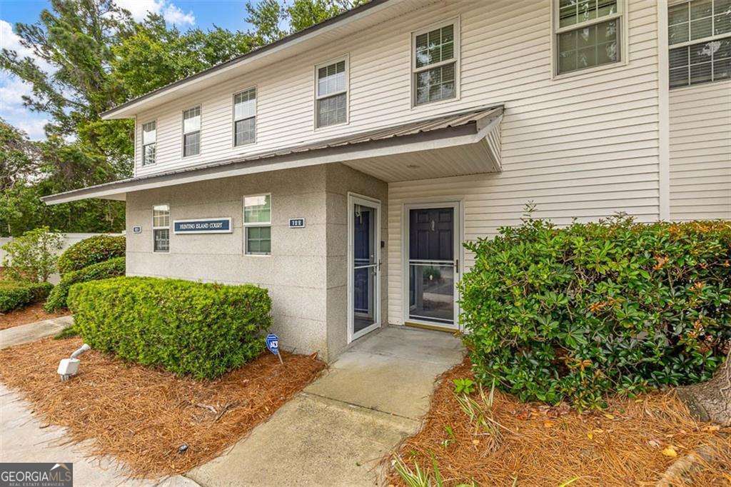Welcome to Island Square on Saint Simons Island! This 2-bedroom, 2.5-bath townhome is quietly tucked away in the back of the gated community, offering a peaceful retreat with great amenities. Each bedroom features a private ensuite bath, wood and tile flooring throughout, and generous closet space. The living and dining areas flow nicely together, with built-in cabinets and a sliding door leading to a private paver patio, ideal for relaxing or entertaining guests. The updated kitchen offers an efficient layout and connects to the convenient laundry room. Enjoy generous storage and low-maintenance living. Island Square features a gated entrance, community pool, tennis courts, and fitness center. Located close to shopping, dining, and with easy access on and off the island, this home offers an excellent opportunity to enjoy the island lifestyle full-time or part-time.