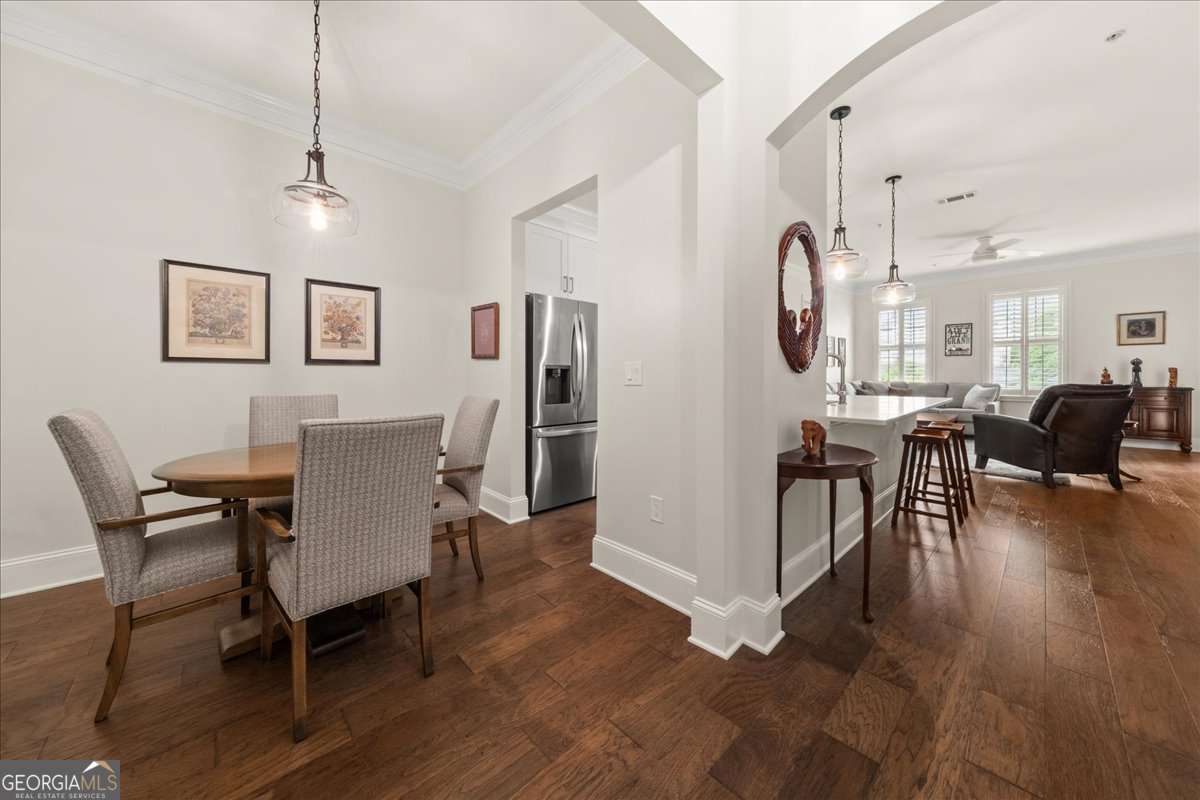 Welcome home to this beautifully renovated 2-bedroom, 2-bathroom condo located in the heart of Historic Vinings. This home features ALL new cabinets, counters, tile, flooring, carpet, lighting and paint throughout. The kitchen offers a large island, new cabinets, quartzite counters, backsplash and appliances. This floor plan offers two master suites with large bathrooms and walk in closets. Enjoy the spacious master suite opening to a luxurious master bath featuring a large tiled walk in shower, double vanity with new cabinets, and quartz counters. Meticulously maintained condo with NEW HVAC, New Water heater, New Flooring, lighting, door hardware and all new finishes! The open floor plan has an abundance of windows and natural light, plus custom shutters for privacy. Relax on the private patio overlooking retail shops. Enjoy Vinings Main deluxe amenities including concierge, pool, fitness center, club room, guest suite, conference room and courtyard with fireplace. Two deeded parking spaces on SAME LEVEL in covered gated garage. Enjoy the perfect blend of charm and convenience just steps from Vinings Jubilee's shops, restaurants, fitness facilities, coffee shops, weekly farmers market and more.Live inside the perimeter with low Cobb County taxes. Whether you're downsizing or looking for the perfect intown retreat, this condo offers unbeatable walkability, style, and value in one of Atlanta's most desirable neighborhoods.