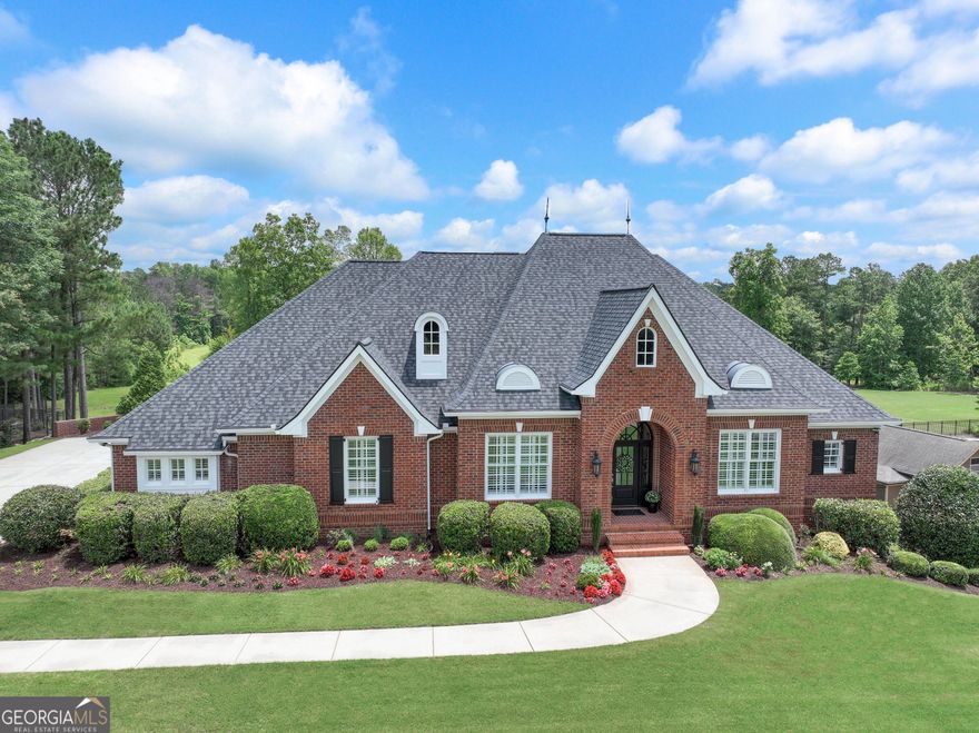 LUXURY LAKEFRONT LIVING AT ITS FINEST IN BEAUMONT FARMS! THIS EXTRAORDINARY FRENCH COUNTRY RANCH SHOWPLACE WITH FINISHED TERRACE LEVEL IS PERFECTLY SITUATED ON A PREMIER 1.3 ACRE WATERFRONT ESTATE LOT WITH 140' OF SHORELINE AND SPECTACULAR PANORAMIC WATER VIEWS AS FAR AS YOU CAN SEE! This home is a true treasure, reimagined and remodeled to perfection, showcasing impeccable craftsmanship, completely on trend with every imaginable upgrade and the latest designer touches! From the foyer you immediately see the amazing lake views and sense the elegance of this home with the open flowing layout, volume ceilings, expansive picture windows, and rich wide-plank hardwood floors throughout the main level! The lovely formal dining room is perfect for hosting dinner parties or intimate gatherings, and there is also an executive office with 8' French doors for privacy!  NOW...step into this spectacular sun-filled great room, and the panoramic lake views will simply take your breath away! It almost feels like an 'ocean view!' The heart of this home is the CHEF'S DREAM-COME-TRUE kitchen, on trend for today's lifestyle and entertaining with TOP-OF-THE-LINE GE CAFE stainless steel appliances, including a commercial gas cooktop, all with soft-brushed gold handles! Creamy white handcrafted cabinets, quartz counters, center gathering island, striking French Country hood, pendant lighting, and walk-in pantry make this kitchen exceptional! The sunny breakfast room is perfect for casual dining and is convenient for entertaining on the porch and rear deck, all while you are relaxing, grilling out, or just taking in the water views! The "primary wing" offers complete privacy with a king-sized retreat offering sparkling water views to wake up to every morning...plus an elegant spa bath enhanced by quartz vanities, luxurious brushed marble shower and frameless door, soaking tub, heated tile floors (of course), and custom closets! There are two more generous guest bedrooms on the main level adjoined by a beautifully remodeled Jack-and-Jill bath too! Take the stairs to a gigantic bonus room and bath, perfect for a teen retreat, guest suite, or studio!  AND THERE IS STILL MORE...The incredible terrace level/in-law suite offers a wonderful recreation/media room, and guest en-suite with its own bath, all with picture windows overlooking the lake, plus volume ceilings too! Plenty of room for storage or future expansion with approximately 1800 square feet of unfinished area with endless possibilities, PLUS there is a designated workshop area with double doors for storing kayaks, canoes, lawn equipment, or even a few vintage cars! This professionally landscaped yard is perfect for the kids or pets to run...or can easily accommodate an Olympic size pool and cabana!  NOTABLE UPGRADES: Rinnai tankless water heater, three-car garage, and maintenance-free brick exterior! PRIME LOCATION WITH QUICK ACCESS TO AWARD-WINNING SCHOOLS, RESTAURANTS, SHOPPING, AIRPORT, AND I-85! ABSOLUTELY AMAZING!