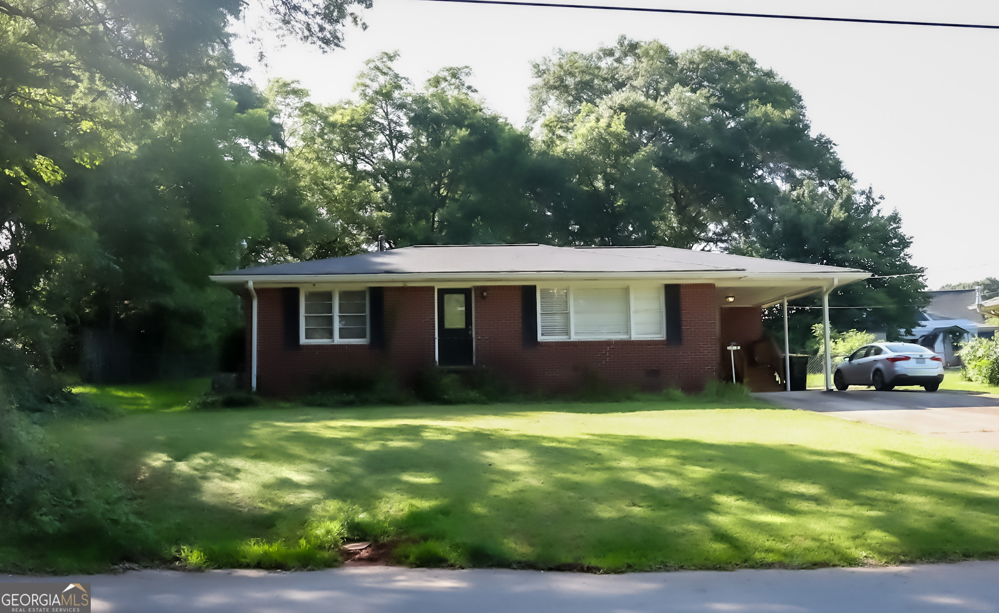 This two bedroom, one bath brick, 1960 bungalow holds much of it's original charm, and sits comfortably on a manageable .33 acre lot. That includes a storage shed and an out building with plumbing and electricity. This is all located in the historic walking community of Fairburn Georgia; near Theaters and unique shopping.
