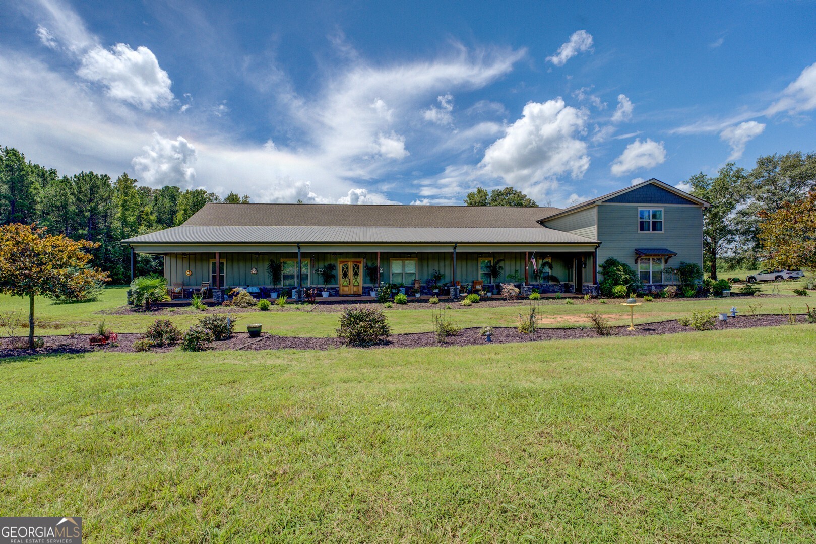 This truly remarkable home promises to be the perfect sanctuary for you and your family. On an expansive 20.43 ac. this custom-built home offers sweeping views, with features designed for luxurious living. Completed in 12/2023, W/ Certificate of Occupancy on 12/05/23, this masterpiece boasts approximately 5,198 heated sq. ft of thoughtfully designed space. Stunning front porch W/ 1,023 sq. ft. (11x93), relax and enjoy the abundant wildlife that roam the property. **Superior Insulation**: Crafted w high-quality spray foam insulation, the home ensures energy efficiency, backed by demonstrably low utility bills. - **Custom Climate Control**: Enjoy personalized comfort with a sophisticated HVAC system, featuring a dedicated 2.5-ton unit exclusively for the master suite, complemented by two 4-ton units for main dwelling & a 3.5-ton unit servicing the office & upstairs apartment, all managed by dual thermostat controls. - **Open-Concept Layout**: The home's design fosters a gentle flow between spaces, creating an inviting & airy atmosphere. **Gourmet Kitchen**: Indulge your culinary passions in the meticulously designed kitchen, featuring a sprawling 5x10-ft granite-top island w/ bar seating. Highlights include: - A two-sided farm sink w/ motion sensor arch faucet. - An ingeniously designed pop-up stand mixer station, equipped for ease of use. - High-end stainless steel appliances, including a 46" Forno gas stove with eight burners & dual gas ovens, professional-grade vented hood, double electric ovens with built-in Bluetooth capabilities. - whisper-quiet dishwasher, ensuring serenity even during meal prep. **Elegant Coffee Bar & Pantry**: kitchen is more than functional; a masterpiece of design, featuring chic coffee bar w stylish tile backsplash & built-in drawer microwave. Expansive pantry & butler's pantry designed for entertaining, - Dual refrigerator/freezer units w/ ample storage. - Central granite-top cabinet w/ ice maker. - 8-drawer food pantry w/ soft-close doors for effortless organization. Overlooking two dining rooms, adorned with judge panels & crown molding, the kitchen leads to an inviting pool room, complete w/ a cedar wall for dart games, the perfect spot for entertainment. Large laundry rm., **Inviting Living Area**: The grandeur of the living room captivates w/ a gas-burning fireplace and stunning black walnut mantel, accompanied by custom built-in cabinetry. 24-ft. ceilings, expansive windows connect you to the outdoor oasis, featuring a stone wood-burning fireplace, ample space, primed for an outdoor kitchen expansion. **Luxurious Master Suite**: generous Master Bedroom (20x20), where tranquility reigns. ensuite bathroom features: - low-entrance tiled shower with rainfall showerhead, full tiled bench, oasis for relaxation. - two-person jetted soaking tub, complete with its water heater, nestled within a beautifully tiled sanctuary, a dedicated nook for television, ensuring leisure during moments of self-care. - walk-in closet that dreams are made of, equipped with dual-sided drawers and abundant space, alongside a secure safe room for peace of mind during storms. **Versatile Office/In-Law Suite**: This functional space, complete with a private entrance, measures 26x21 ft boasts 10-ft ceilings w/ elegant crown molding. Enjoy the custom low-step tile shower, granite vanity w/ soft-close doors, spacious walk-in closet. **Charming Above-Garage Apartment**: This delightfully appointed dual-entry apartment offers: - Laundry rm., kitchen featuring side-by-side refrigerator, electric stove w/ built-in air fryer, dishwasher, full-size farm sink- sleek stainless steel. l- A luminous living room with soaring 12-foot ceilings and expansive windows, sep. dining room, oversized bathroom that includes a clawfoot tub, separate walk-in closet, complemented by a dedicated game room/man cave. Experience the lifestyle you've always dreamed of in this enchanting home!