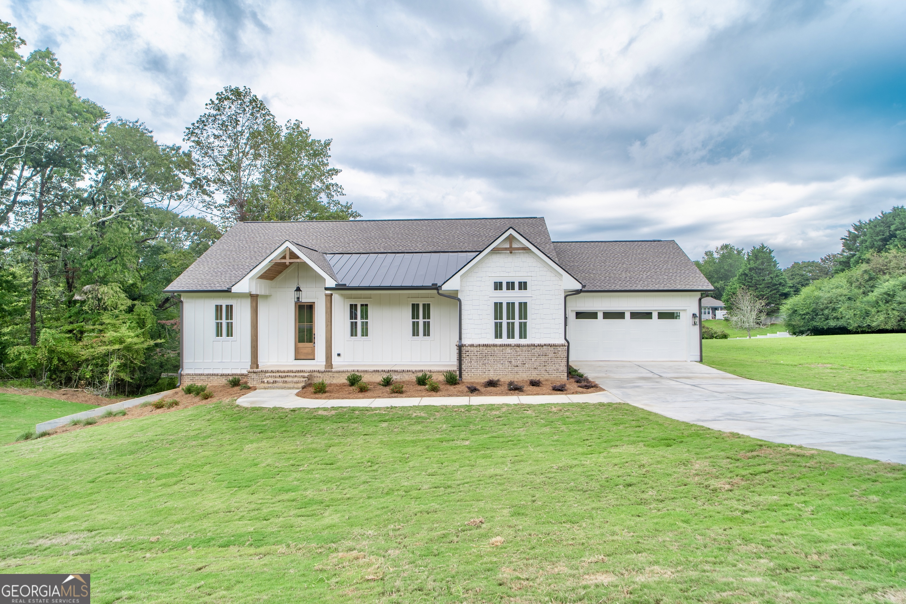 Brand new, custom modern-craftsman home in the heart of the North Georgia mountains, surrounded by historic Dahlonega, scenic views & wine country! A 5bd/3.5ba custom ranch on a partially finished basement gives this house all the space, features, and flexibility to become your 'forever home'. With the master suite on the main level, sweeping daylight from room-to-room, and a huge finished recreation/entertainment/living room space on the lower terrace level, this home has it all, offering the perfect blend of timeless architecture, practical living, and modern comfort. Step inside to find an open-concept ranch floor plan with designer finishes, soaring ceilings, and abundant natural light. The main level features a spacious great room, a chef-inspired kitchen with custom cabinetry & island, granite countertops, and a walk-in pantry - ideal for entertaining or everyday living. The luxurious master suite boasts a spa-like bathroom and spacious closets, while a custom laundry room, two additional bedrooms and a full bath complete the main level. The lower terrace level offers incredible flexibility with tall ceilings, 2 bedrooms, a full bathroom, bonus living space - and over 800sf of unfinished space, perfect for storage or putting in place your own final touches. Enjoy peaceful mornings or sunset views from the charm of the rocking-chair front porch, or the gorgeous covered back deck with huge telescoping sliding doors; either way, you'll love being part of the Sky Country neighborhood, one of Dahlonega's hidden treasures! This home is just minutes from the historic Dahlonega Square, the brand new Northeast Georgia Hospital, numerous wineries, the Chattahoochee National Forrest, the University of North Georgia, and an easy commute to Atlanta-Hartsfield Jackson International Airport! This property is truly a statement of best-in-class modern mountain living, with easy access to anything you'd want to do with the people you enjoy most.