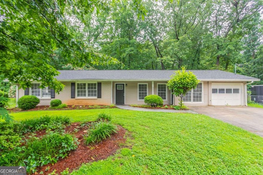 Tucked away in the quiet Indian Forest Estates neighborhood, this charming 4-sided brick ranch is full of potential. With original hardwood floors, a spacious living room, and separate dining area, the home offers a layout that's easy to personalize. The large, level backyard is ideal for gardening, play, or future outdoor entertaining. Enjoy the convenience of an attached garage and laundry room, plus easy access to I-285, downtown Decatur, and major shopping centers. No HOA and no rental restrictions make this property a great opportunity for both homeowners and investors alike. This home has been virtually staged to illustrate its potential.