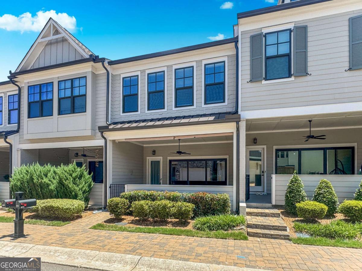 Available Now! Like-New Luxury Townhome in Sought After Village at Towne Lake! Beautiful finishes throughout. Inviting, open-concept floorplan. The large slider doors in the family room open to a great outdoor space with a covered porch for entertaining. Enjoy cooking and relaxing w/ an open chef-inspired kitchen & living area w/ 10+ ft ceilings. This home has modern touches like stone countertops w/ plenty of cabinets and walk-in pantry as well as upgraded lighting . Upstairs you will notice 10ft ceilings and an open rail staircase. The owner's suite showcases a modern light double vanity w/ upgraded countertop, an oversized shower & expansive walk-in closet. Also upstairs, 2 guest BRs with walk-in closets, 2nd full bath with tiled walls and a laundry room. As a bonus the community is gated, beautifully maintained and offers a range of amenities such as: a pool, pickleball court, bocce ball, fire pit, a dog park and more. Resident Benefit Package included. Check out our 5-Star Reviews on Google. Rent quoted reflects discount for on time payment, ask for details.