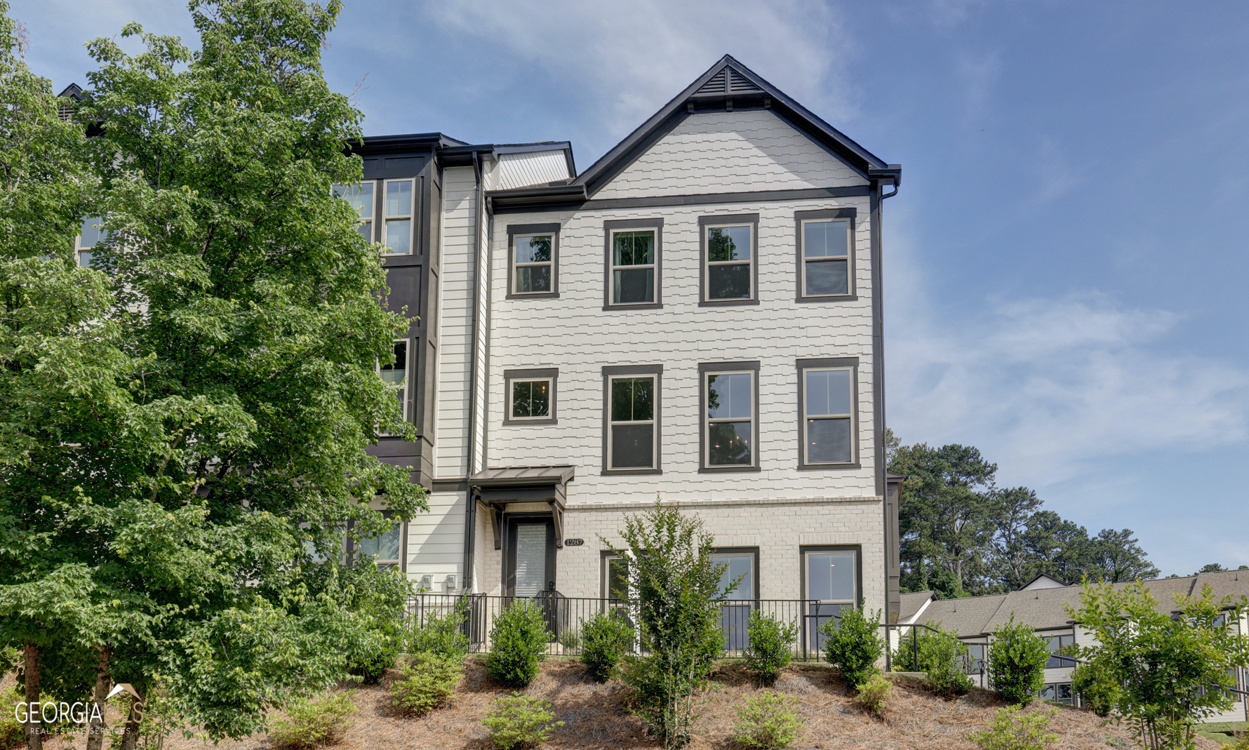 OPEN SUN JUNE 18th 2-4 PM! This South facing end unit is better than new and following only a year of gentle inhabitance is offered in impeccable condition for immediate occupancy. The location and the view however are as compelling as the condition in that it is an end unit on an elevated corner lot, with the lot situated across from the Mason Mill Dog Park. This setting offers an open vista of green space and treetop views. While the home is situated close to the Park, Clubhouse and Swimming Pool, the elevated placement affords a sense of seclusion and tranquility. And speaking of location, entertain much? Whether hosting a small dinner party or a sizable event, ample guest parking is merely steps away! This home is flooded with natural light from the abundant, elevated bay windows that offer one of the very best views in the community right from your front door and dining area. Ample windows allow vistas to the north, south, and east. The spacious open plan on the main living level is large enough for comfortable seating, dining, cooking, and relaxed entertaining. The living space features an office nook with storage cabinetry and is tucked away near the triple windows with access to your deck built for dining. Beautiful hardwoods compliment the cool crisp white cabinetry in the gorgeous chef's kitchen which is accented by the 15' quartz island with integrated storage and sleek stainless steel appliances. The kitchen upgrades include a gorgeous white subway tile backsplash, a five-burner gas cooktop, a stainless steel vent hood, and stunning quartz. For a second work from home hub, choose a separate office space on the finished terrace level that includes a convenient full bath. On the second level, the oversized private primary bedroom suite boasts a walk in closet and luxurious bathroom with oversized shower with rainfall showerhead, and floor-to-ceiling upgraded tile. Two additional bedrooms on the second level offer ample sleep, play, and work spaces. Parkside at Mason Mills offers perfect intown living in Decatur and robust amenities: pool, fitness center, fully furnished clubhouse with games and business center, walking trails, and creekside dog park. Nestled next to Mason Mill Dog Park with easy access to the PATH's South Peachtree Creek walking trail. The neighborhood provides easy access to Emory, the CDC, VA Hospital, Decatur Square, Toco Hills, shopping, restaurants, and more.
