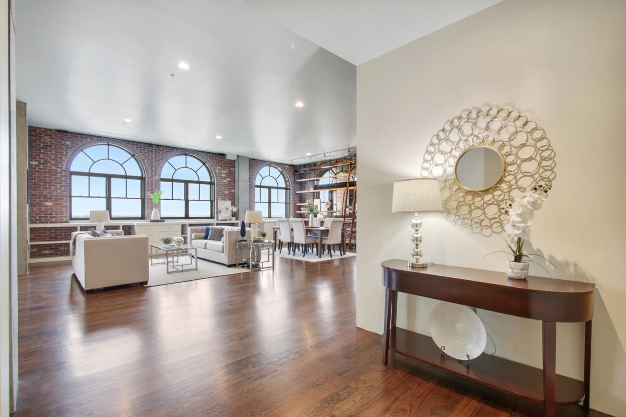 Sophisticated and Elegant Loft in highly desirable Mathieson Exchange Lofts! Stunning 14th NW corner penthouse with an amazing covered terrace with breathtaking views of Buckhead and unobstructed views of Vining's and Kennesaw, and second covered patio with views of Buckhead Triangle. This spacious loft has a flowing open layout with 13-ft ceilings, exposed brick walls, palladium windows offering tons of natural light, beautiful dark hardwoods throughout. The well-equipped kitchen is an entertainer's delight. Featuring a large kitchen island, KitchenAid refrigerator,  gas stove, dual dishwashers all in steel, and a walk-in pantry. The spacious living area opens to the dining area and sitting area. All feature stunning views, custom cabinetry, floor-to-ceiling library wall and opens to both covered patios. Antique European doors open to a large and well-appointed owner's suite offering a peaceful retreat with a sitting area, a splendid spa bath w/ dual vanity, a large tile shower bench, and spa tub. An oversized walk-in closet provides plentiful storage. The secondary bedroom features a sitting area, walk-in closet, and an en-suite full bath. This Loft comes with a storage unit and 2 deeded gated parking. Enjoy incredible amenities including club room, rooftop terrace, pool, spa, gym, 24/7 concierge, and EV Charging stations available. Buckhead's finest Dining, Shopping, and Entertainment seconds away! Mathieson Exchange Lofts is located on a quiet tree-lined street overlooking Historic Buckhead Forest!