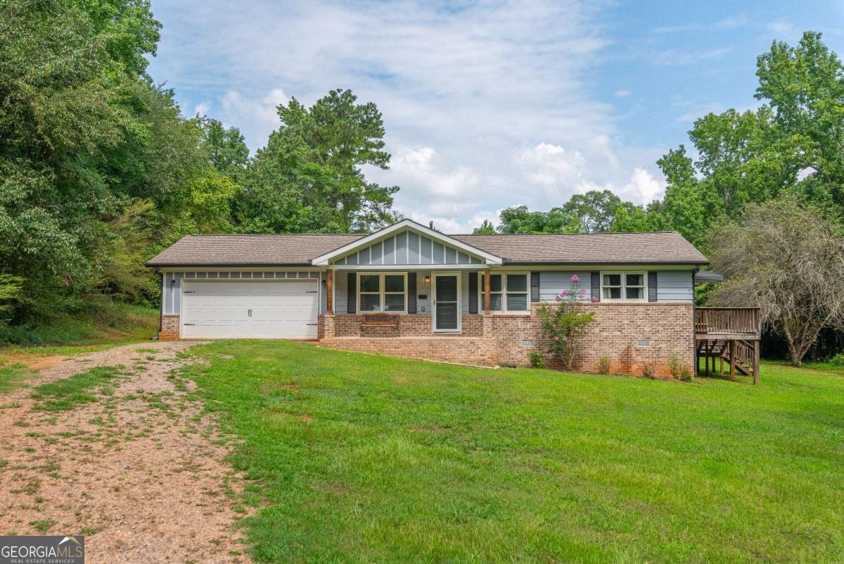 Conveniently located just minutes from Hancock Rd and Willow Springs Church Rd, this beautifully maintained one-level home offers comfort, style, and functionality in the heart of Social Circle. Featuring 3 bedrooms and 2 full bathrooms, this home boasts an open-concept layout that seamlessly connects the living room and formal dining area-perfect for everyday living and entertaining. The updated kitchen includes stained cabinetry, a stylish backsplash, and stainless steel appliances, creating a warm and modern cooking space. The primary ensuite offers a tub/shower combo and an updated vanity, while the secondary bathroom features a stand-alone shower. Each bedroom provides ample space and natural light. The home is serviced by a private well and septic system-both replaced in 2019, offering peace of mind and long-term value. With its thoughtful updates and desirable location, this home is move-in ready and perfect for anyone seeking single-level living in great neighborhood. Discounted rate options and no lender fee future refinancing may be available for qualified buyers of this home.