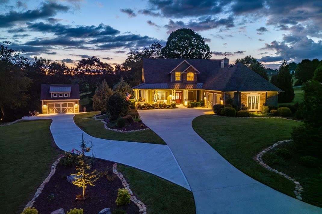 Experience the epitome of refined living, where every detail has been carefully curated to create a harmonious blend of opulence & comfort, in this craftsman style home nestled in a prestigious golf course community. Intentional landscaping frames the exterior, while inside, greeted by a haven of warmth. The heart of the home may be the gourmet kitchen that attracts culinary creativity, the cozy fireplace that reaches to the soaring ceiling, or the sliding doors to the cozy screened porch that floods the room with natural light. With its generous size, flexibility for your needs is key - invite friends & family with ample space & endless entertainment. Expansive back patio graced with dining area, hot tub, & 2 fire pit areas all designed & put in place for sharing cherished moments. Sitting on just over 2 acres for a well intended balance of privacy & company. What are you waiting for? The mountains are calling!
