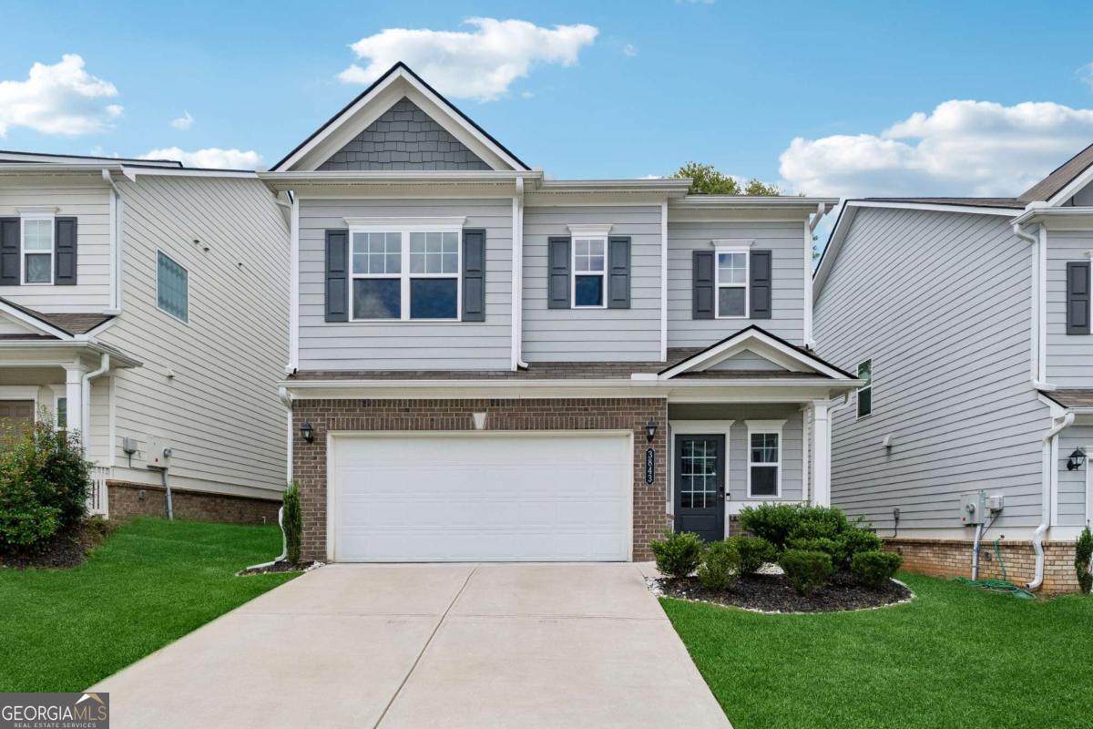 Welcome Home! This beautifully maintained property showcases the exceptional craftsmanship of SmithDouglas Homes and is perfectly situated near top-rated schools, shopping, dining, and offers quick access to I-75, Hwy 41, and the scenic Kennesaw Mountain hiking trails. Step inside to a bright, open-concept main level filled with high-end upgrades. Host unforgettable gatherings in the spacious great room featuring a cozy gas fireplace and seamless flow into the gourmet kitchen. The kitchen boasts a large center island, designer quartz countertops, stainless steel appliances including a gas range and microwave, stylish subway tile backsplash, and crisp white shaker cabinetry. The dining/breakfast area overlooks a private, low-maintenance backyard with premium artificial turf-no mowing required! Upstairs, you'll find an impressive owner's suite along with three additional generously sized bedrooms, a full secondary bathroom, and a conveniently located laundry room-all on the same level. Don't miss your chance to own this nearly new home-just 3 years young and ready for you to make it yours!