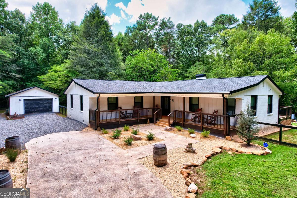 Fully Remodeled Retreat in the Heart of Wine Country! Welcome to 52 Homer Wright Rd-where modern luxury meets mountain charm! Nestled on 3+ unrestricted acres surrounded by five local vineyards and cider houses, this completely renovated home offers peace, privacy, and premium finishes throughout. The long concrete driveway leads you to your own private oasis with a detached garage, ideal for storage, a workshop, or future guest space. Inside, you'll find top-of-the-line appliances, a bright open-concept layout, and designer touches at every turn. Step out onto the expansive entertainer's deck, featuring a solid surface fireplace, perfect for cozy evenings and year-round gatherings. Whether you're looking for a private estate, a short-term rental investment, or a vineyard getaway, this property checks every box.
