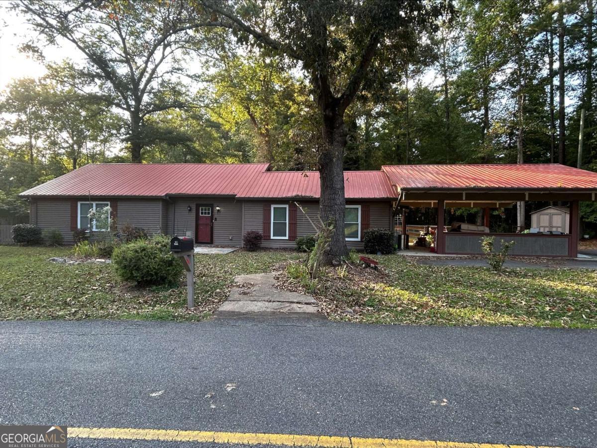 This cozy 3BR / 2 BA Ranch Home features 3 BR / 2 BA - Huge Kitchen with Granite Countertops and Eat-In Area; Huge, Open-Concept Family Room with Dining Area and Sliding Door leading out to Private Deck; Oversized Master Bedroom with sliding Door leading out to private deck; Two spacious secondary bedrooms; Vinyl Plank Flooring throughout living areas; Metal Roof; Front & Side Doors with Storm Doors; Shutters on front exterior; Level Backyard with Wood Privacy Fence; Two-Car Carport; Asphalt parking space added; NO HOA !!! MORE PHOTOS COMING SOON!