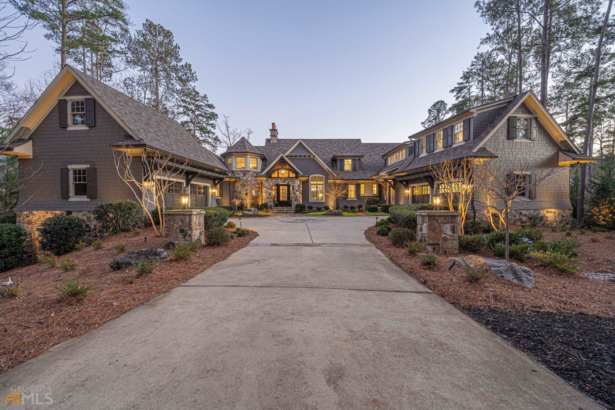 SIMPLY THE BEST - Reynolds Lake Oconee lakefront estate! This exceptional property is located in the prestigious Jackson Ridge section with amazing views of Lake Oconee, unique privacy and over 200 feet of lake frontage. Luxurious 6-bedroom home of the highest construction quality, too many upgrades to list and remodeled in 2021 like-new. Special features inside include open floor plan perfect for entertaining, elevator, executive study with balcony, family room with walk-around custom bar, wine cellar, 8 seat theater and custom bunk room. Outside features 4 car garages, screened porch with fireplace, flagstone open deck, flagstone patio with grill area, resort style pool/jacuzzi, pavilion with stone fireplace and of course the sweeping lake views. 5-minute boat ride to Richland Point and The Ritz Carlton. ONE-OF-A-KIND property for the discriminating buyer who wants the best at Lake Oconee!