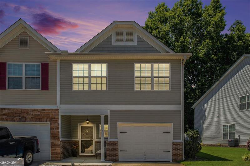 Showcase kitchen transformation + move-in ready! Welcome to this beautifully updated 3-bedroom, 2.5-bath end-unit townhome in the highly desirable Flowery Branch area. The recently renovated kitchen features brand-new countertops, refreshed cabinetry, and modern appliances-perfect for cooking enthusiasts and ideal for entertaining family and friends. Enjoy hardwood floors throughout, a cozy living room with a fireplace, and an upstairs laundry area for added convenience. Step outside to a spacious deck and private patio overlooking a peaceful wooded greenspace-ideal for morning coffee or evening gatherings. The community offers fantastic amenities, including a pool, playground, and open green areas. Plus, you're just minutes from Lake Lanier, as well as shopping and dining options. Located within Hall County Schools and zoned for Flowery Branch Elementary, West Hall Middle, and Flowery Branch High-known for its strong academics and "Falcons" spirit. With easy access to I-985 and GA-400, commuting is a breeze. Don't miss out-this turnkey townhome delivers the perfect blend of modern updates, comfort, and unbeatable location!