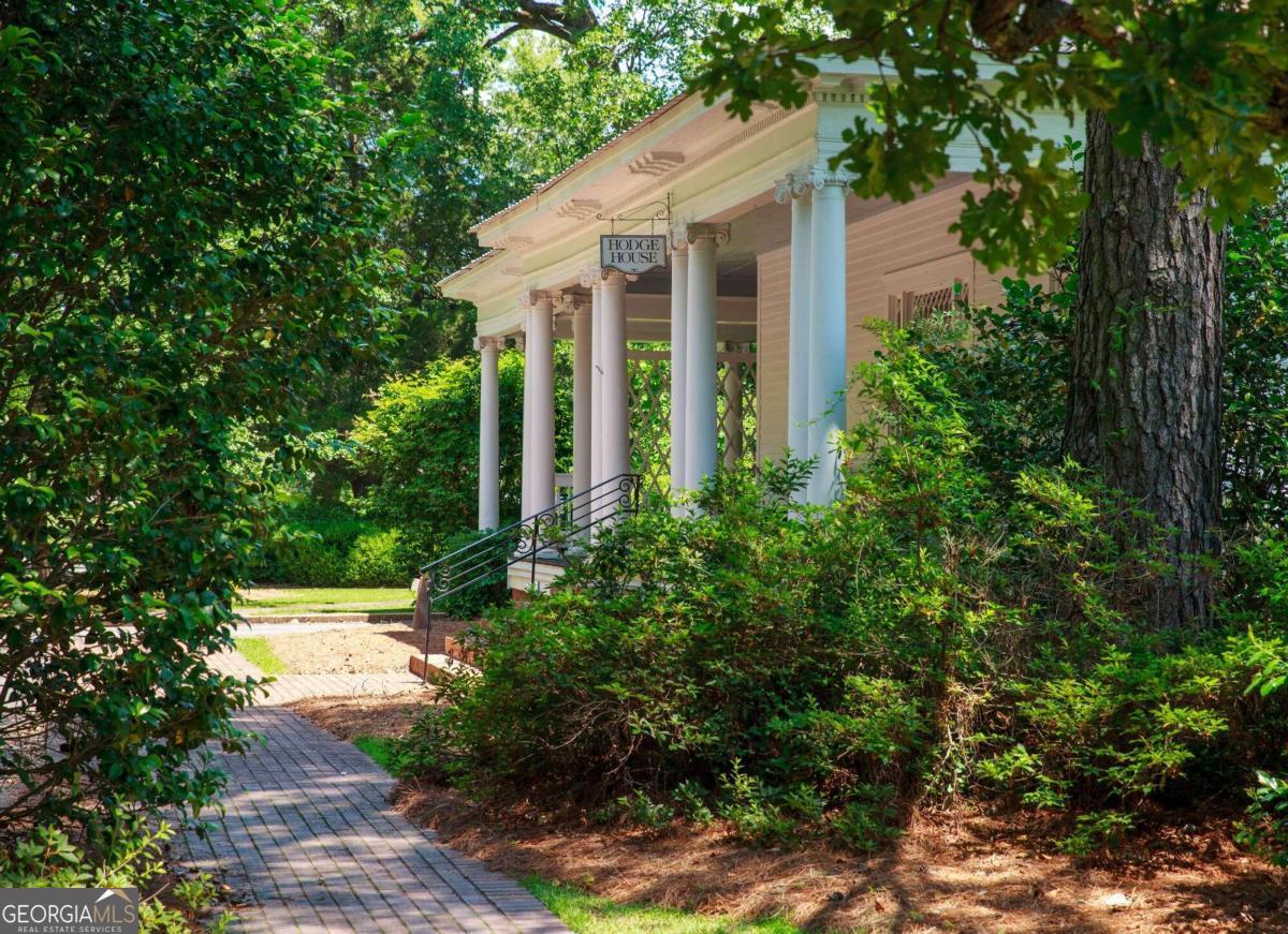 Amazing wedding venue, with multiple historic structures that include 26 guest rooms with en-suite baths, outdoor and indoor venues, elaborate gardens, and a full scale commercial kitchen with attached bar and restaurant. Office includes a commercial laundry. Six classic farmhouse style clapboard houses with huge front (and rear) porches (circa 1900), eight relocated rustic "tenant" cabins that date back to the 1800s, arranged thoughtfully around an open quad. A very large covered pavilion that can host a terrific reception, that is next to the commercial kitchen, bar, and restaurant that is also ideal for rehearsal dinners. Elegant gardens and fountains, and large open fields for recreation and overflow parking. It is hard to imagine a more perfect place for a large wedding, only 1.5 hours south of Atlantas Hartsfield International Airport. Space for expansion.