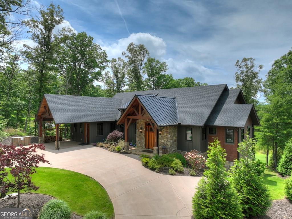 Experience Elevated Mountain Living at 658 Old Toccoa Loop-Nestled along the scenic 6th fairway of the prestigious Old Toccoa Farm, this exceptional 4-bedroom, 4-bathroom custom home offers an unparalleled blend of refined luxury and natural beauty. Located within an exclusive guard-gated community, Old Toccoa Farm features an award-winning 18-hole golf course and over a mile of pristine Toccoa River frontage - a haven for those who value privacy, recreation, and mountain elegance. Designed with both comfort and sophistication in mind, this thoughtfully crafted home showcases panoramic golf course views, high-end finishes, and seamless indoor-outdoor living. The open-concept main level features a chef's kitchen complete with quartz countertops, stainless steel appliances, a wine fridge, and a custom coffee bar - perfect for morning routines or entertaining guests. The spacious living room is anchored by a modern fireplace and expansive sliding glass doors that open to a covered deck with a stacked stone fireplace, extending the living space into the fresh mountain air. The primary owner's suite on the main level offers serene views and a luxurious en-suite bathroom with custom tilework. A second main-level guest suite provides comfort and privacy for visitors. All bathrooms are elegantly appointed with granite vanities, walk-in showers, and a relaxing jetted tub. Downstairs, the fully finished terrace level is designed for fun and relaxation, featuring a game room with a regulation-size pool table, shuffleboard, wet bar, and an array of board games - a true entertainer's dream. Step outside and discover multiple covered outdoor living spaces, including a 7-person hot tub, grilling area, and cozy seating around the fireplace - perfect for gathering after a day of golf or exploring the nearby trails and river activities. Whether you're seeking a full-time residence or a luxurious weekend escape, this proeprty offers turnkey mountain living!