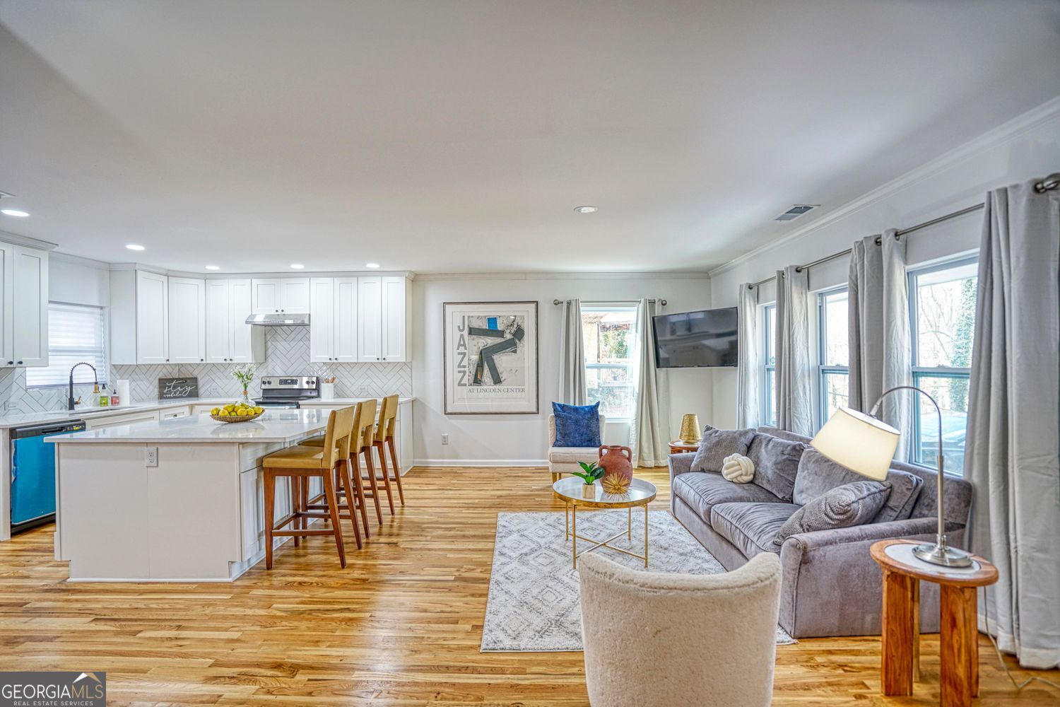 Welcome to 2230 Beecher Circle SW, a beautifully remodeled single-family home in the sought-after Beecher Hills neighborhood of Atlanta. This 3-bedroom, 2.5-bath residence offers 2,200 sq ft of thoughtfully designed living space, blending modern updates with timeless charm. Interior Highlights Open-concept floor plan with a seamless flow between the dining and living areas, perfect for entertaining. Contemporary kitchen featuring white cabinetry, a spacious island, breakfast bar, and sleek solid-surface counters. Stainless steel appliances complete the modern look. Double master bedrooms, each designed for comfort and flexibility. Luxurious primary bathroom with a double vanity, separate tub/shower, and stylish tile finishes. Warm and inviting flooring with a mix of ceramic tile, wood, and modern finishes throughout. Exterior & Lot Situated on a generous 0.64-acre lot with mature trees and a private, wooded view. Patio and porch spaces for relaxing outdoors. Parking pad with space for 2 vehicles. Located on a private road with both paved and gravel access. Additional Features Recently updated and remodeled for today's lifestyle. Accessibility upgrades, including accessible doors, hallways, kitchen, and bathrooms. Public water & sewer, plus central heating and cooling. Move-in ready with vacant possession for quick closings.
