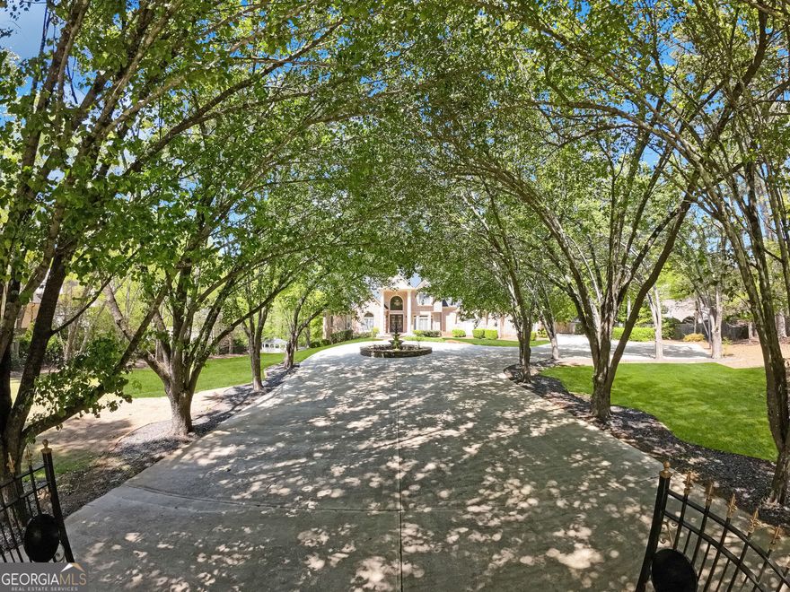Timeless ELEGANCE meets modern LUXURY in this GATED, 4-side BRICK ESTATE situated on just under two private acres near Atlanta Country Club in East Cobb's Award Winning Trifecta of Schools - Walton, Dickerson & Sope Creek. This 6 BD, 6 Full BA & 2 Half BA stately home w/ NEW Roof offers an exceptional blend of sophistication, space & resort-style amenities.Step into a grand two-story foyer featuring a sweeping spiral staircase & dazzling crystal chandelier. Hardwood floors flow throughout the main level featuring a Great Rm w/a 20-foot ceiling, marble fireplace & french doors leading to a covered porch w/tongue and groove ceiling-ideal for outdoor entertaining. The main-level owner's suite is a serene escape w/a private sitting room & fireplace, triple tray ceiling, spa-inspired bath w/granite double vanity & an oversized walk-in closet. The gourmet kitchen features Thermador appliances, a marble island, & a cozy keeping room w/its own fireplace. Upstairs offers three spacious en suites w/tray ceilings, while a separate in-law or teen suite sits privately above the 4-car garage. The terrace level-accessed by a dramatic spiral staircase-boasts an artistic wine storage wall, a large multipurpose room w/ bricked fireplace and kitchenette, 1 BD, 1 Full BA & 2 office/media rms-ideal for entertaining or multigenerational living. The beautifully landscaped grounds feature a private tennis court, charming gazebo  & tranquil water feature. Conveniently located near shopping & dining of Sandy Springs and East Cobb as well hiking & recreation at Sope Creek Trail. Make this exceptional estate your own!