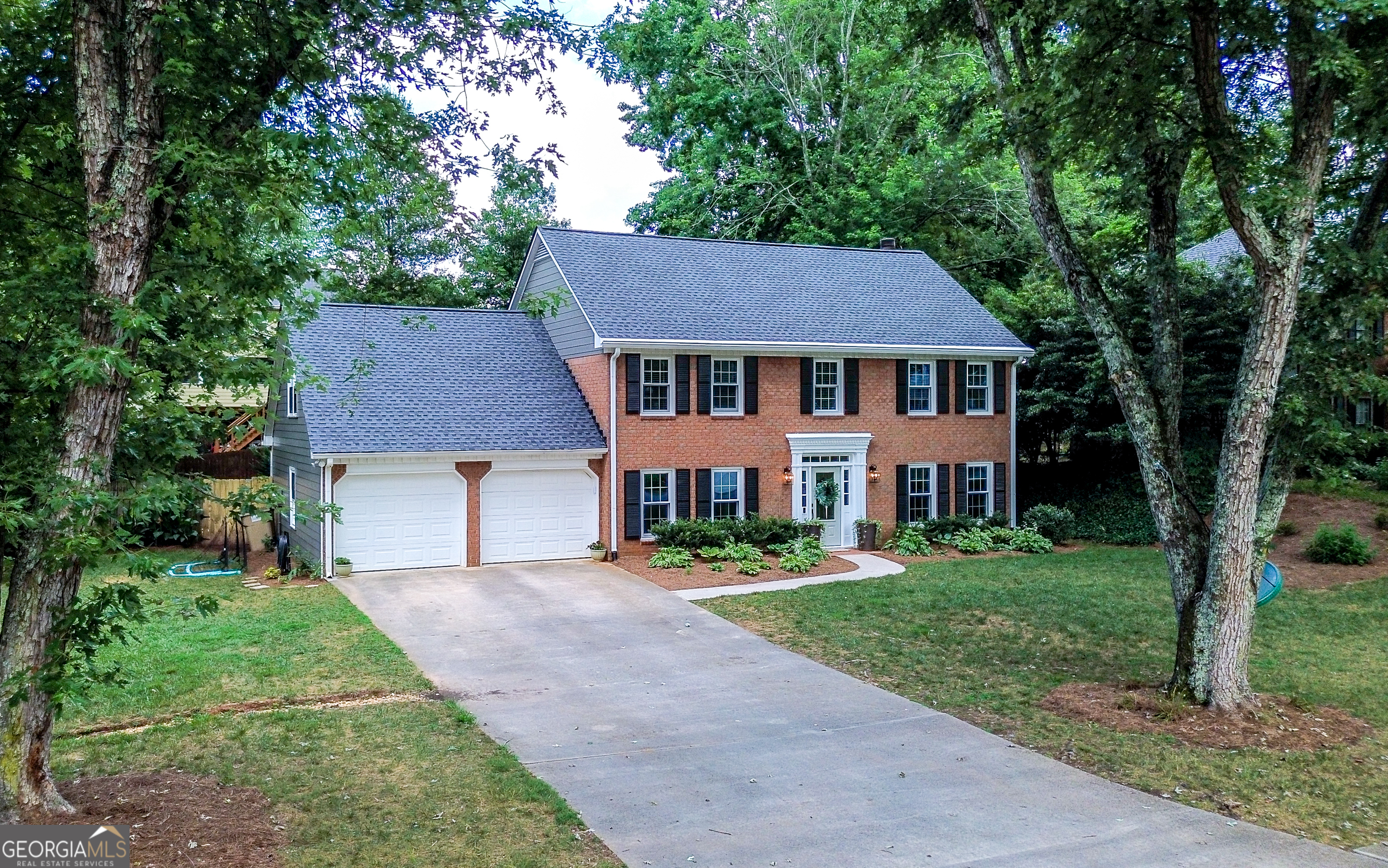 A must see beautifully updated traditional home in the popular East Cobb community of Whitfield complete with a swimming pool and tennis courts. Homes do not come on the market in this neighborhood often because once you are living here... you simply do not want to leave! This brick front traditional home is perfectly situated on a level lot, fenced backyard with gorgeous hydrangeas, fescue lawn, fire pit, cozy seating area under a shady tree in the front yard along with so much more. As you enter this lovely home, to the right is a large bright room which can be used as a library, study, kids play room or even a music room. Seller has recently added NEW solid wood French doors with designer hardware to close this space off if desired. To to left of the stairs when entering the foyer is a full dining room with easy access to a stunning white kitchen complete with expansive granite countertops and stainless appliances. The kitchen also has a spacious sun filled breakfast room with high ceilings and private views of the fenced backyard. There is also easy access to the relaxing large screened porch from the breakfast room, quick access to the fenced backyard as well as an additional door leading inside to the great room. The great room is spacious and has a beautiful brick fireplace, painted wood paneling along with a large bay window area which allows for abundant natural light to fill the room along with adding additional space for seating. Upstairs there are 3 spacious bedrooms serviced by a full bath, large primary bedroom and walk-in closet, updated private NEW bath with an amazing oversized shower. Upstairs also has a huge bonus room which could be used as a 5th bedroom. You can also access this room from stairs that lead up from the entry hall area coming in from the 2 car garage. Just completed brand NEW hardy plank siding outside with freshly painted inside walls & trim with neutral tones. Seller has recently added a NEW architectural shingle roof, NEW Pella windows and screens, NEW luxury vinyl flooring throughout the downstairs, updated primary bathroom with NEW vanity lighting, NEW custom shower, tile and designer plumbing fixtures. HVAC was replaced about 6 years ago.  *** Location is key being within a mile from everything you need including shopping, restaurants and some of the best schools in Cobb County.*** HOA just added a huge TV at the pool/grill area for sporting games and fun! Don't miss this opportunity to live in a popular community with so much to offer!