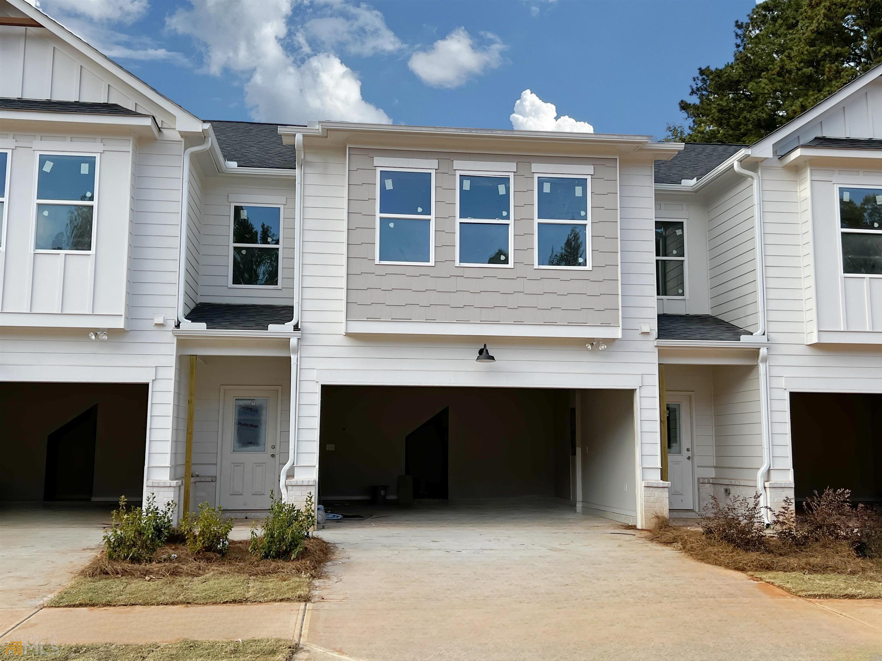 Richardson Housing Group, the Orchard floor plan with covered back porch. Townes at Rockfern community offers a unique collection of rustic urban townhomes that is located just 14 miles northeast of Atlanta, right across the street from Lions Club Park, 3 miles from Tucker, and only 3 miles from the historic, walkable neighborhood called Old Town Lilburn that features restaurants, concerts, city events, and shopping. Our homes are built with a unique blend of soft industrial exterior designs, covered back porches, open floor plan layouts, along with upscale on-trend interior finishes like electric vehicle charging outlets, quartz countertops, LVP flooring, crown molding, stainless steel appliances, white shaker-style cabinets, and owner’s bathrooms that feature oversized fully tiled showers. The homeowner’s association includes lawn maintenance, exterior building maintenance and termite bond. Great Buyer incentives include $7,000 towards closing costs if financing with approved lender.